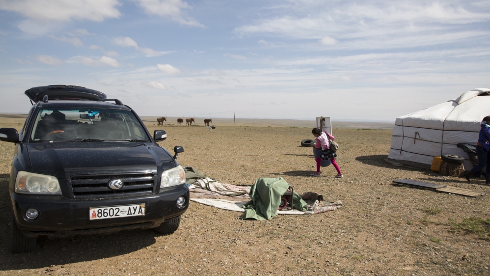 Bujinlkham Damdinsuren packs her equipment on the race morning before her family drives 30km to Tsagaandelger, where the Naadam festival will take place [Hannah Griffin/Al Jazeera]