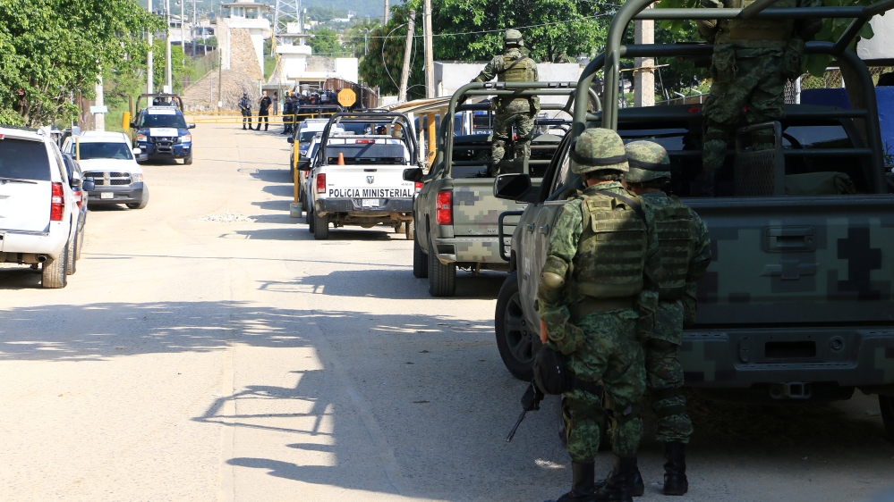 Soldiers stand outside a prison after a riot broke out at the maximum security wing in Acapulco