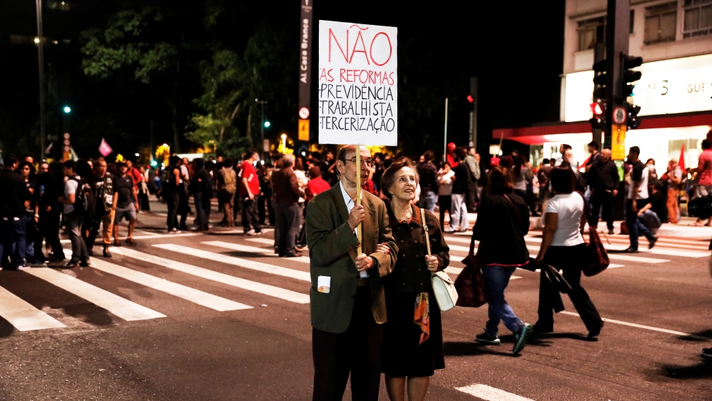 Pensioners hold a banner that reads "Not to social security, labour and outsourcing reforms" during a protest against President Michel Temer''s proposed economic reforms in Sao Paulo