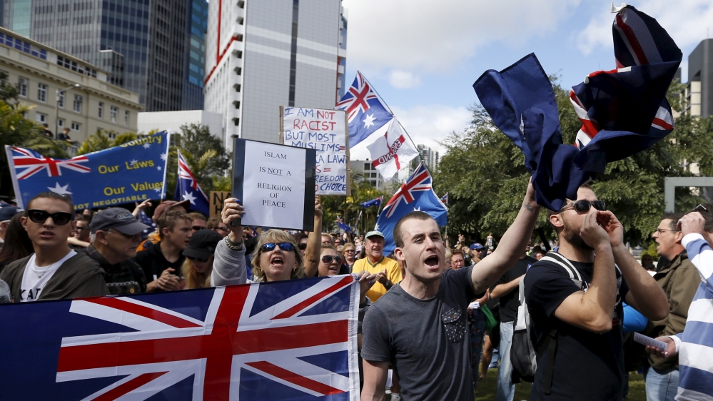 Protestors against Islam in Australia hold up various banners during a "Reclaim Australia" protest in Brisbane