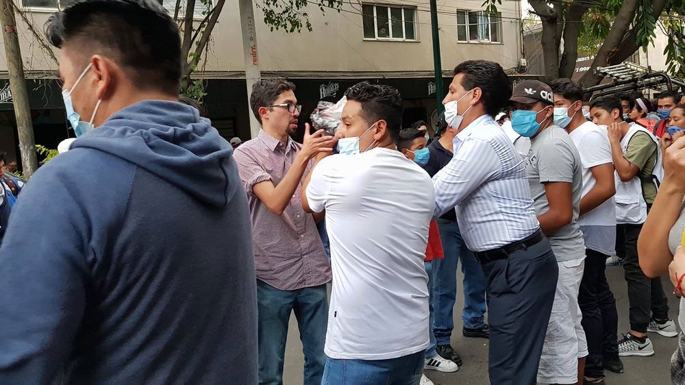 Rescue workers and residents raced to provide try to reach those still trapped in the rubble [Ali Rae/Al Jazeera]