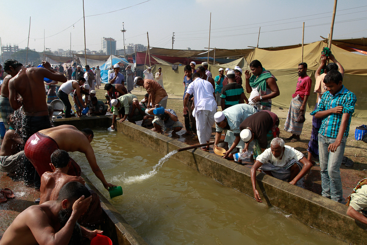 Muslim devotees wash themselves before attending the Prayer Turag. [Mahmud Hossain Opu/Al Jazeera]