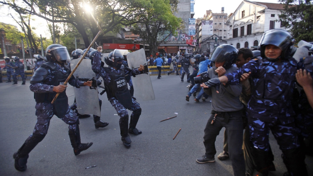 Nepalese policemen charge at members of a splinter faction of the Unified Communist Party of Nepal Maoist during a protest in Katmandu, Nepal, Saturday, March 16, 2013. Police in Nepal''s capital have