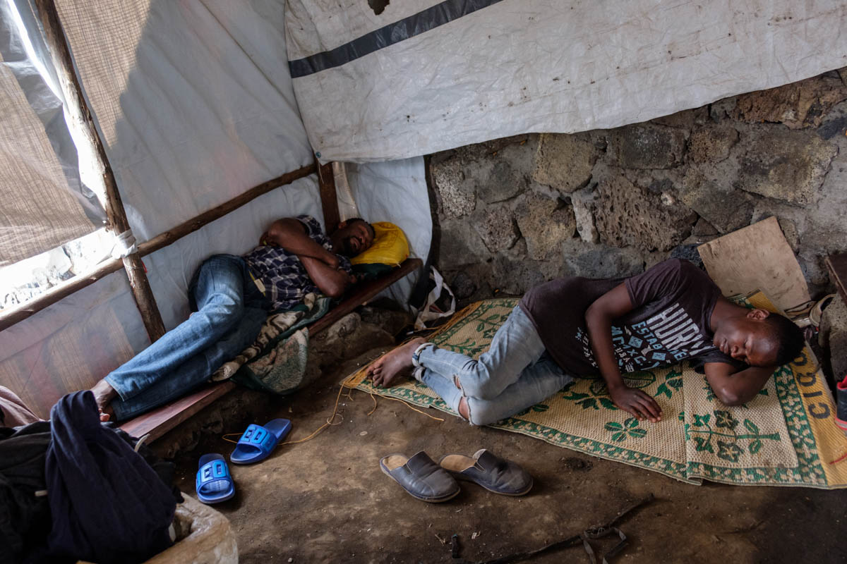 Baba (20) has been living on the streets for four years now. He shares his makeshift hut on the waterfront with a few older guys. He practices his raps at night, in front of the  tent. He believes tha