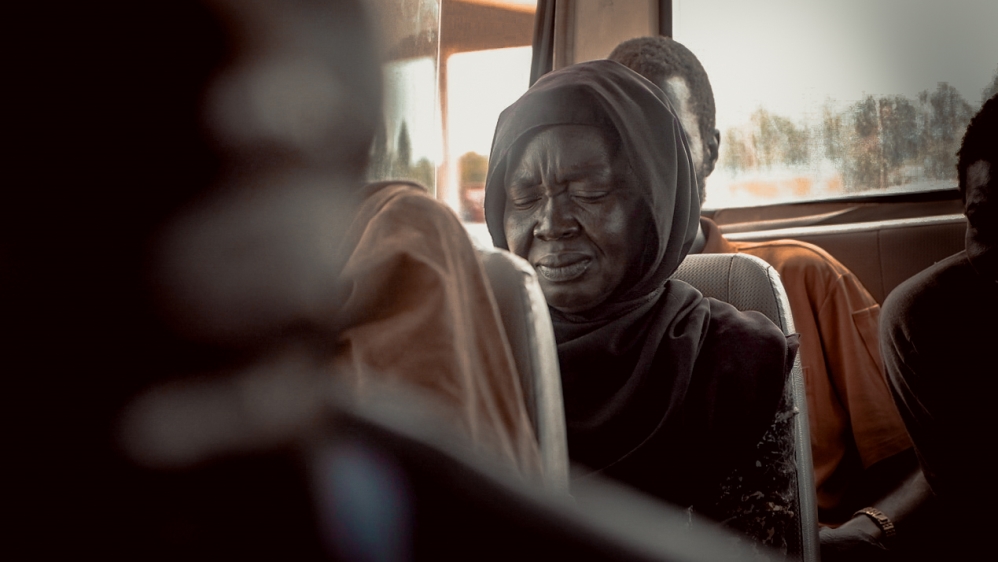 One of the psychologists sits in the bus with the homeless to conduct preliminary medical interviews and assesses their mental health [Jasmin Bauomy/Al Jazeera]