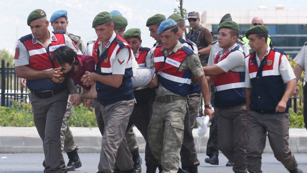 Haldun Gulmez, a soldier accused of attempting to assassinate Turkish President Erdogan on the night of the attempted coup, is carried by gendarmes as he arrives at the court in Mugla