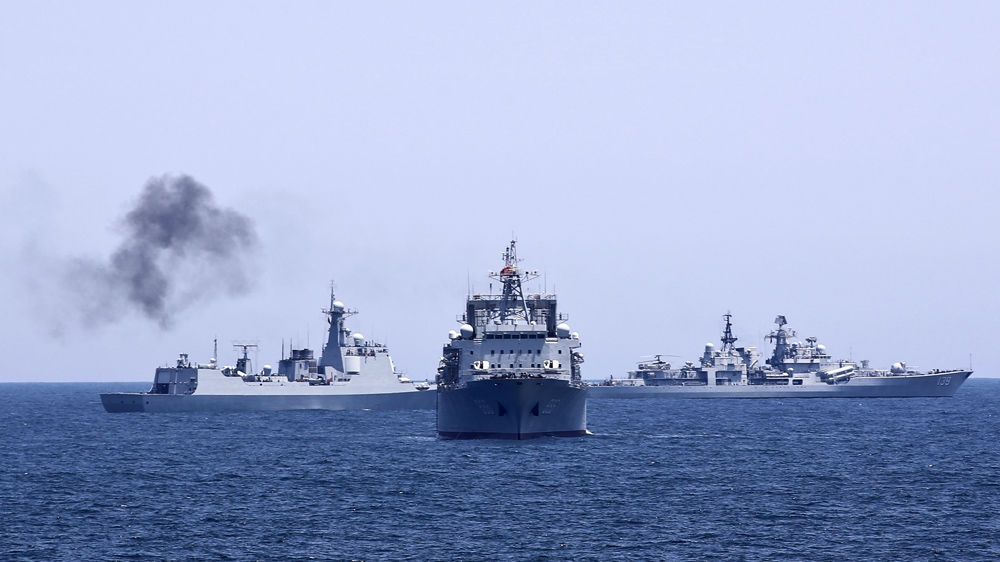 Chinese and Russian naval vessels are seen.