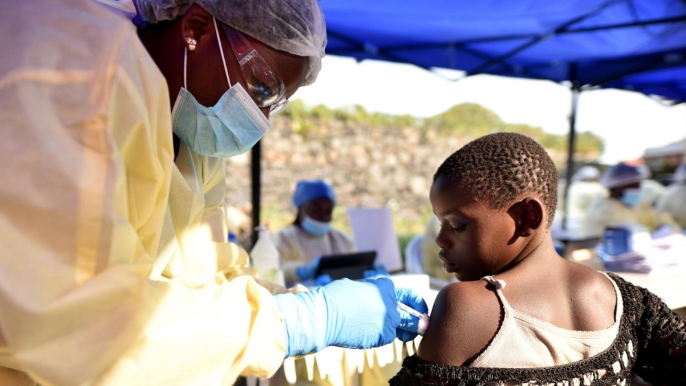 A Congolese health worker administers the Ebola vaccine to a child in Goma, Democratic Republic of the Congo [Olivia Acland/Reuters]