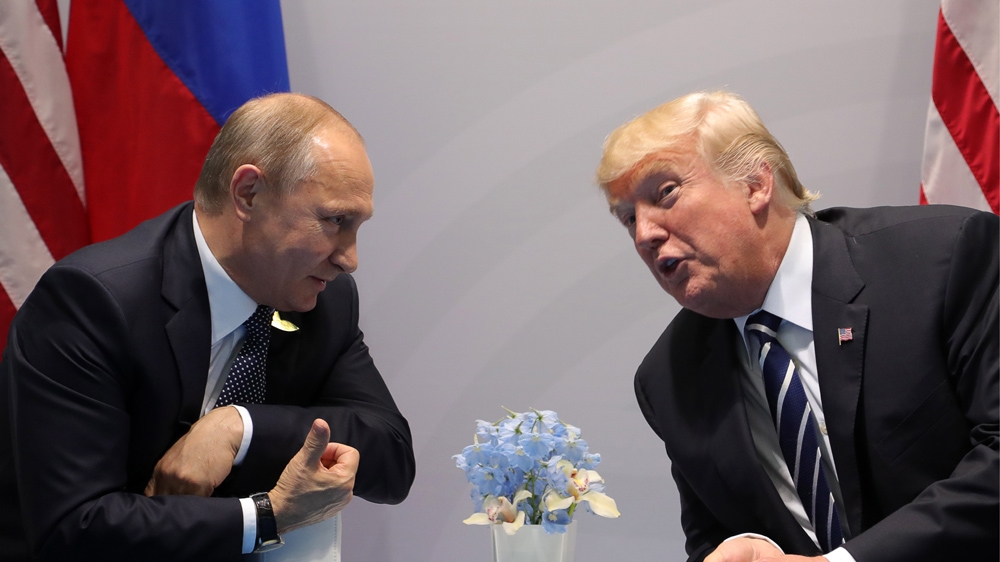 Russia''s President Vladimir Putin (L) and US President Donald Trump talking during a meeting.