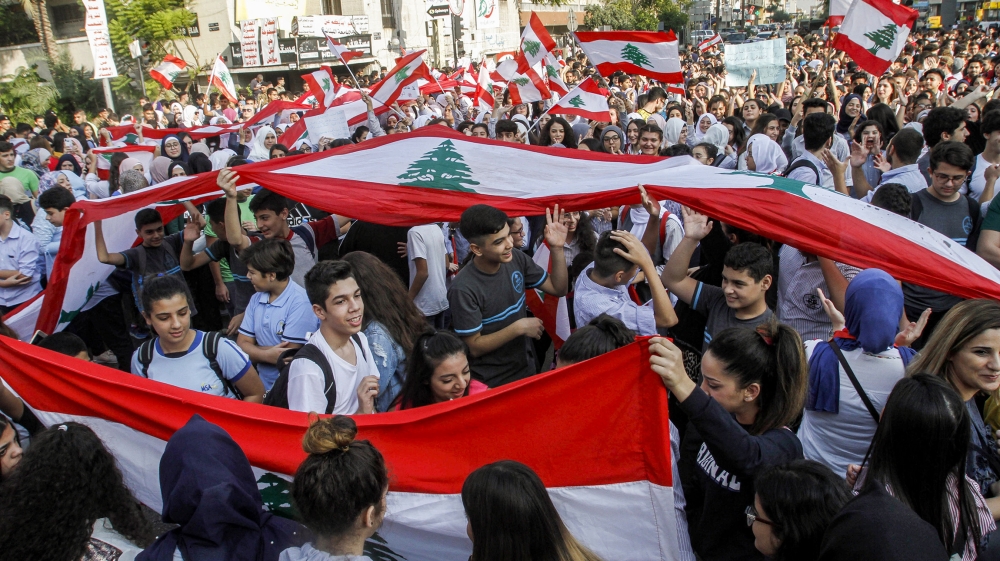 Lebanese students wave national flags and chant slogans as they gather in an anti-government demonstration in the southern city of Sidon on November 6, 2019. Hundreds of schoolchildren led anti-govern