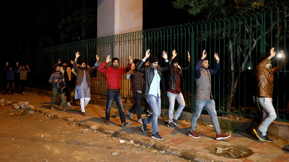 Students raising their hands leave the Jamia Milia University following a protest against a new citizenship law, in New Delhi, India, December 15, 2019. REUTERS/Adnan Abidi