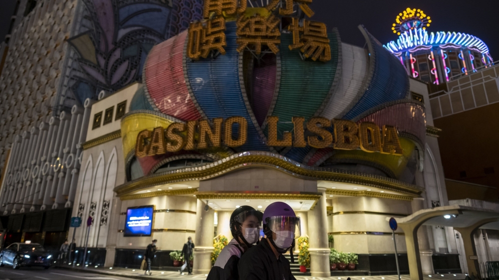 Macau's casinos Grand Lisboa with passersby in the foreground.
