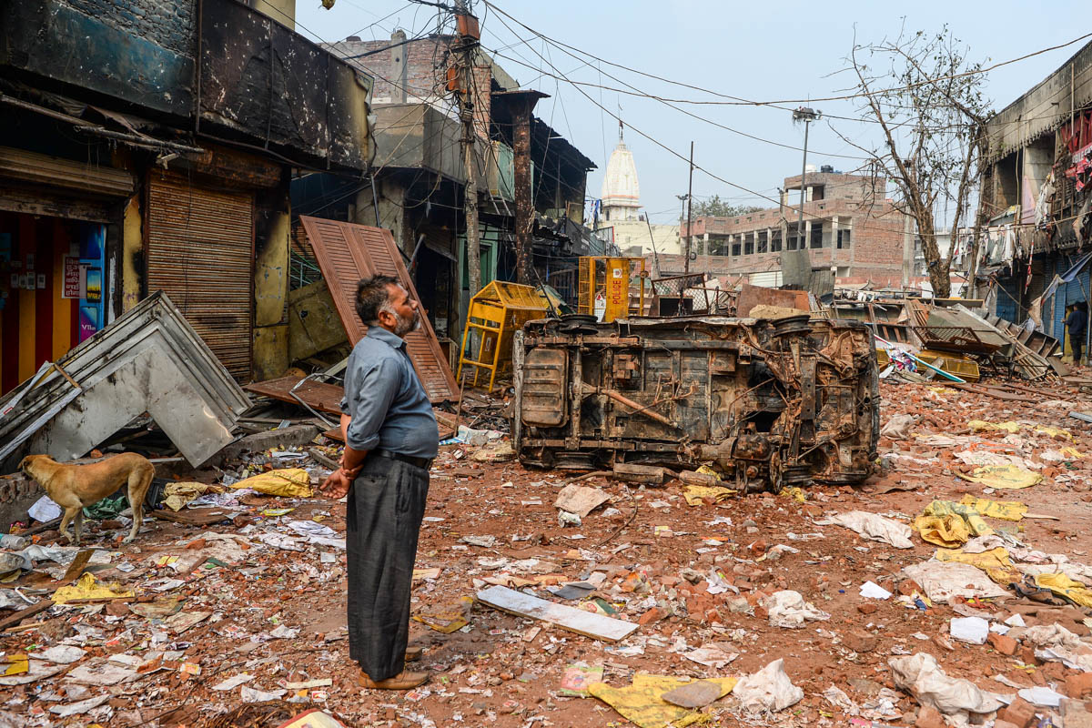 A resident look at burnt-out and damaged residential premises and shops following clashes between people supporting and opposing a contentious amendment to India''s citizenship law, in New Delhi on Feb