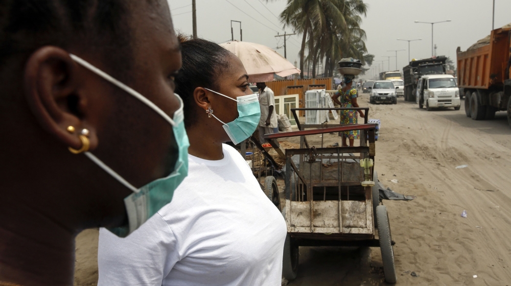 Local residents wear protective face masks on the streets of Lagos, Nigeria, on Friday, Feb. 28, 2020. Nigerian health authorities said they’re tracing everyone who’s been in contact with an Italian m