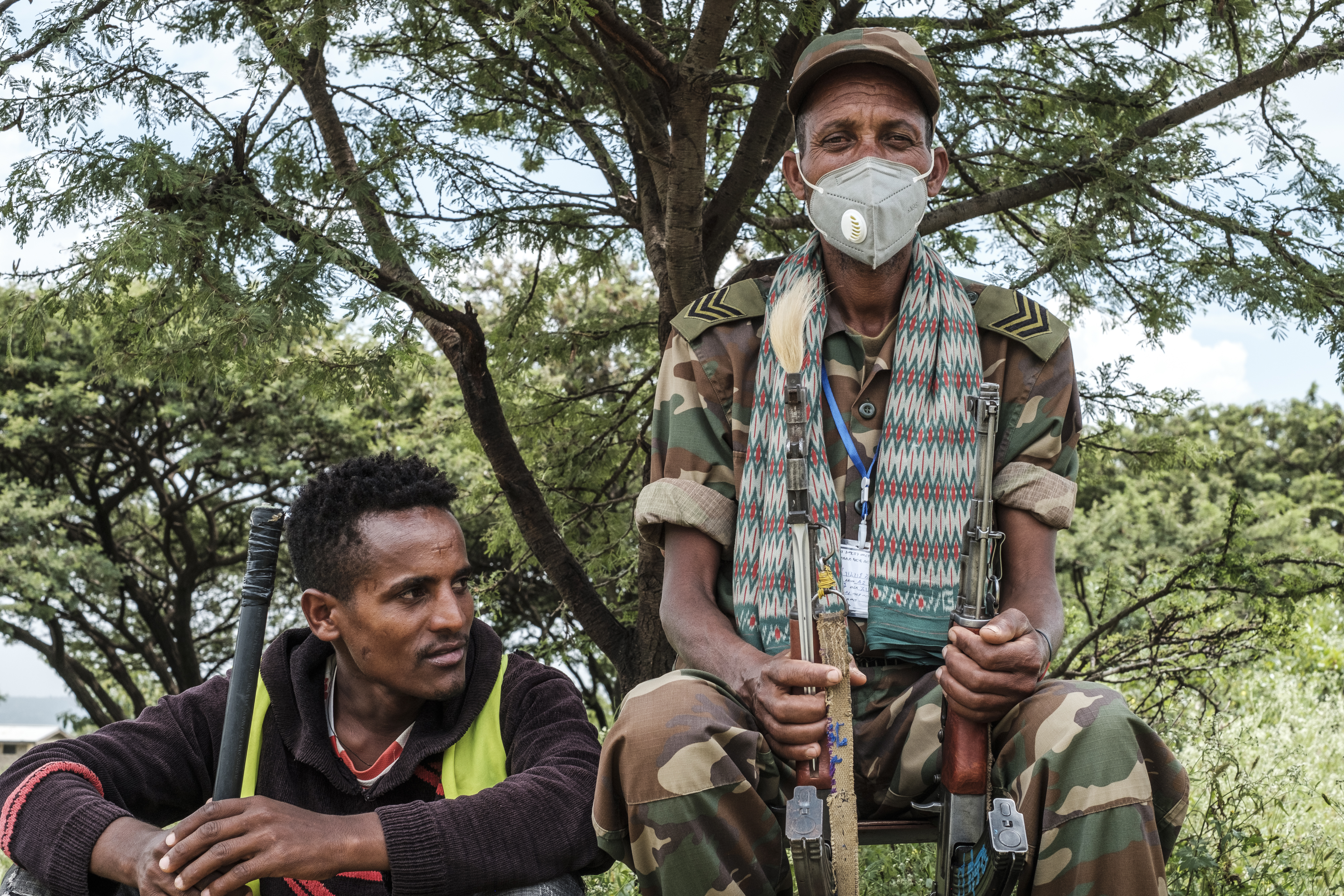 Community members in Tikul guard the entrance of a polling stations during the Tigray regional elections on September 9 [File: Eduardo Soteras/AFP]