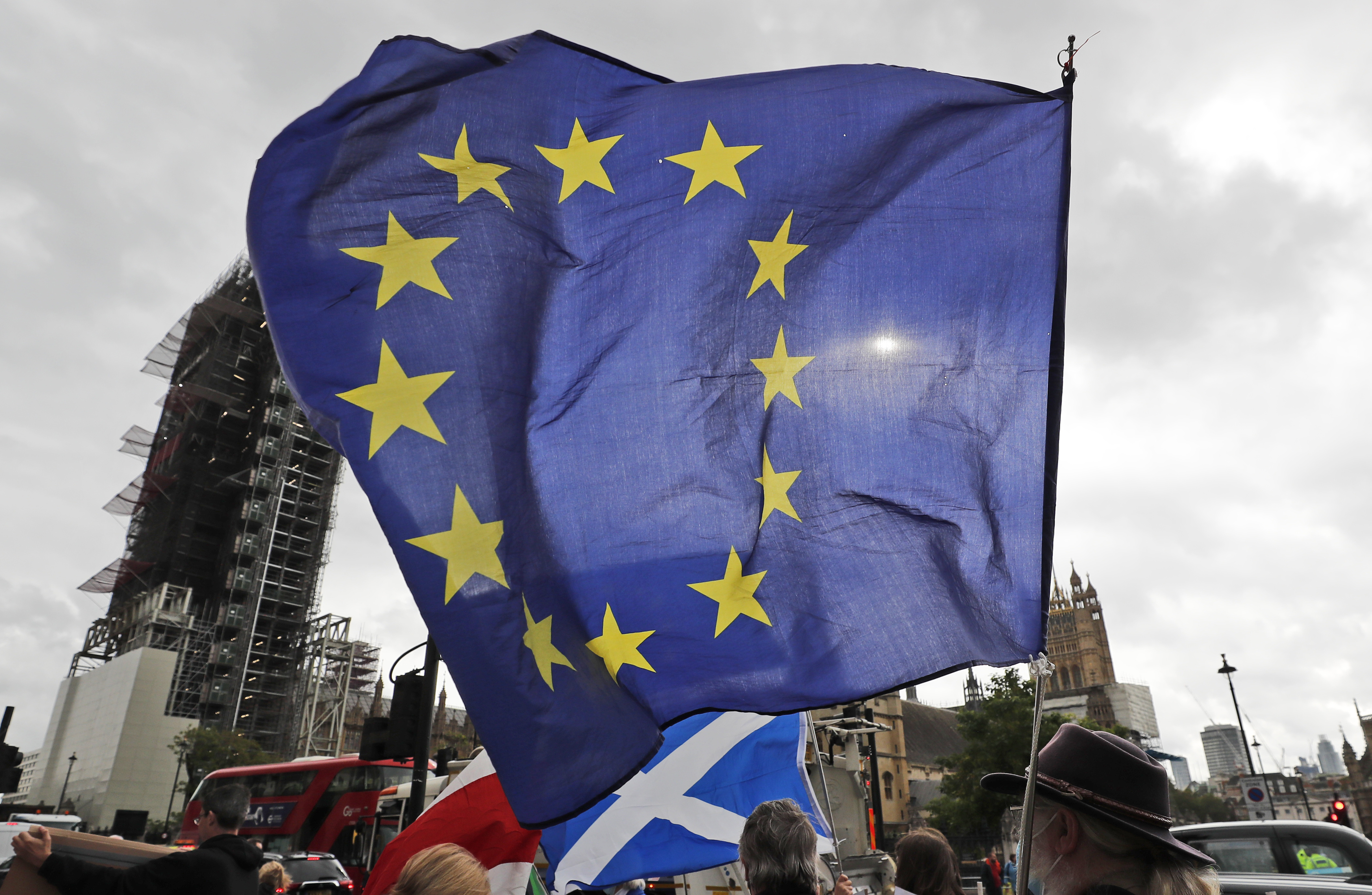 A EU supporter waves a flag in front of Parliament in London, September 30, 2020 [Frank Augstein/AP]