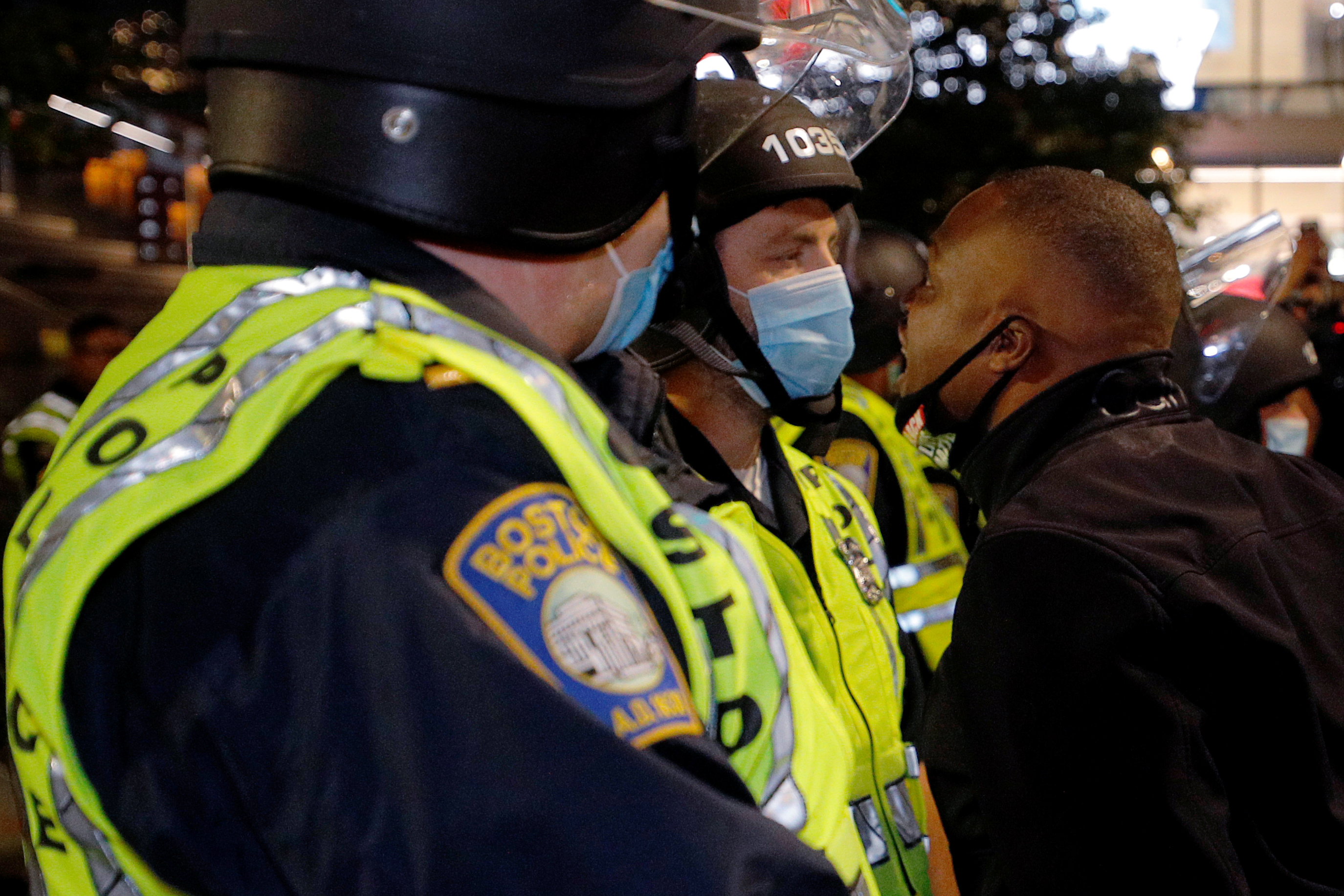 A demonstrator confronts Boston police officers during a &#39;Stand Against Racist Police Murders&#39; march through Boston, Massachusetts, US, on September 25, 2020 [Brian Snyder/Reuters]