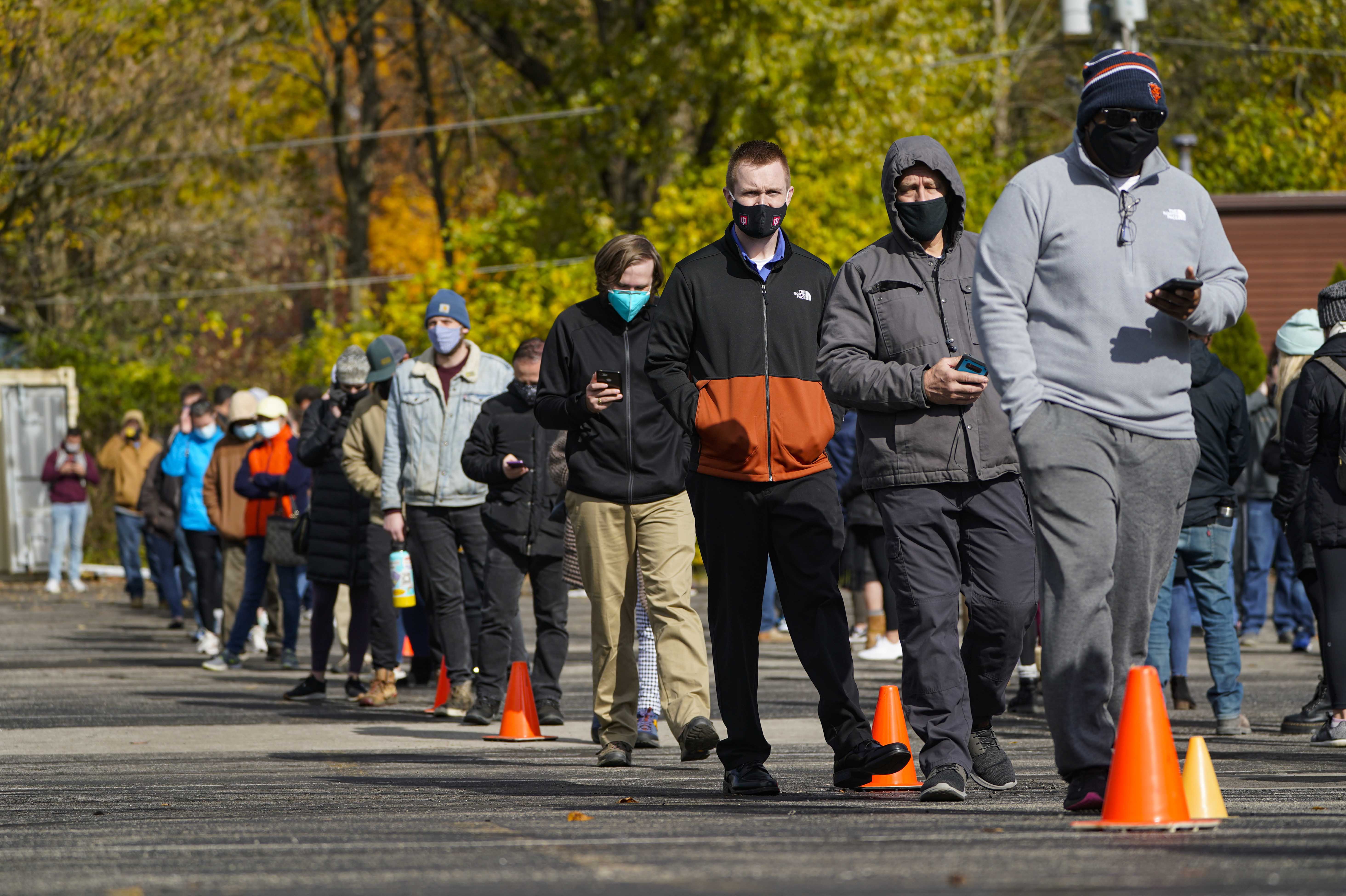 Voters wait in long lines to cast their ballots during early voting at St. Luke&#39;s United Methodist Church in in Indianapolis, Friday, Oct. 30, 2020. The wait to vote at this location is expected to be over 5 hours. (AP Photo/Michael Conroy)