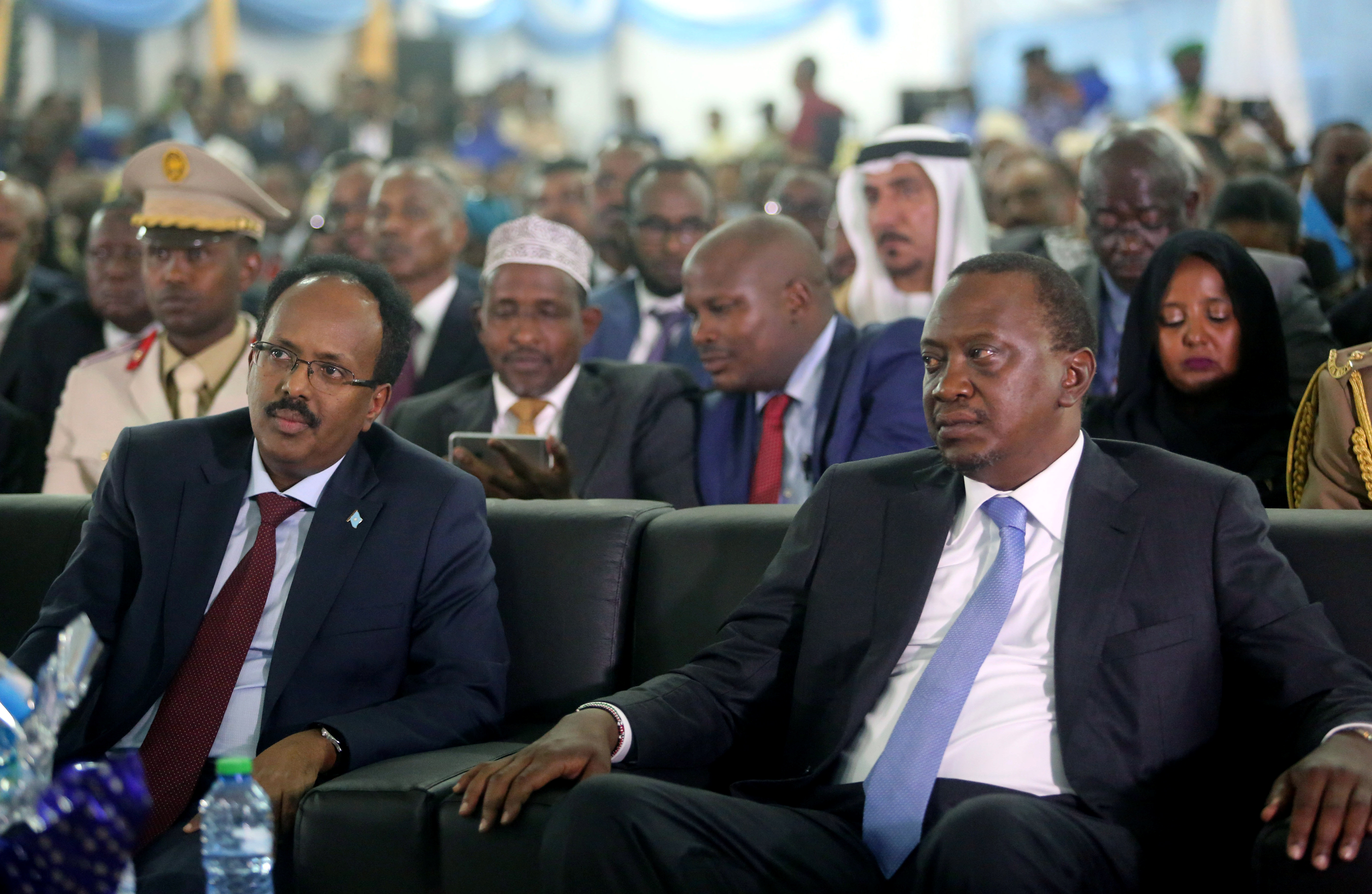 Somalia&#39;s President Mohamed Abdullahi Farmaajo and Kenya&#39;s President Uhuru Kenyatta listen to speeches during Farmaajo&#39;s inauguration ceremony in Somalia&#39;s capital Mogadishu [Feisal Omar/Reuters]