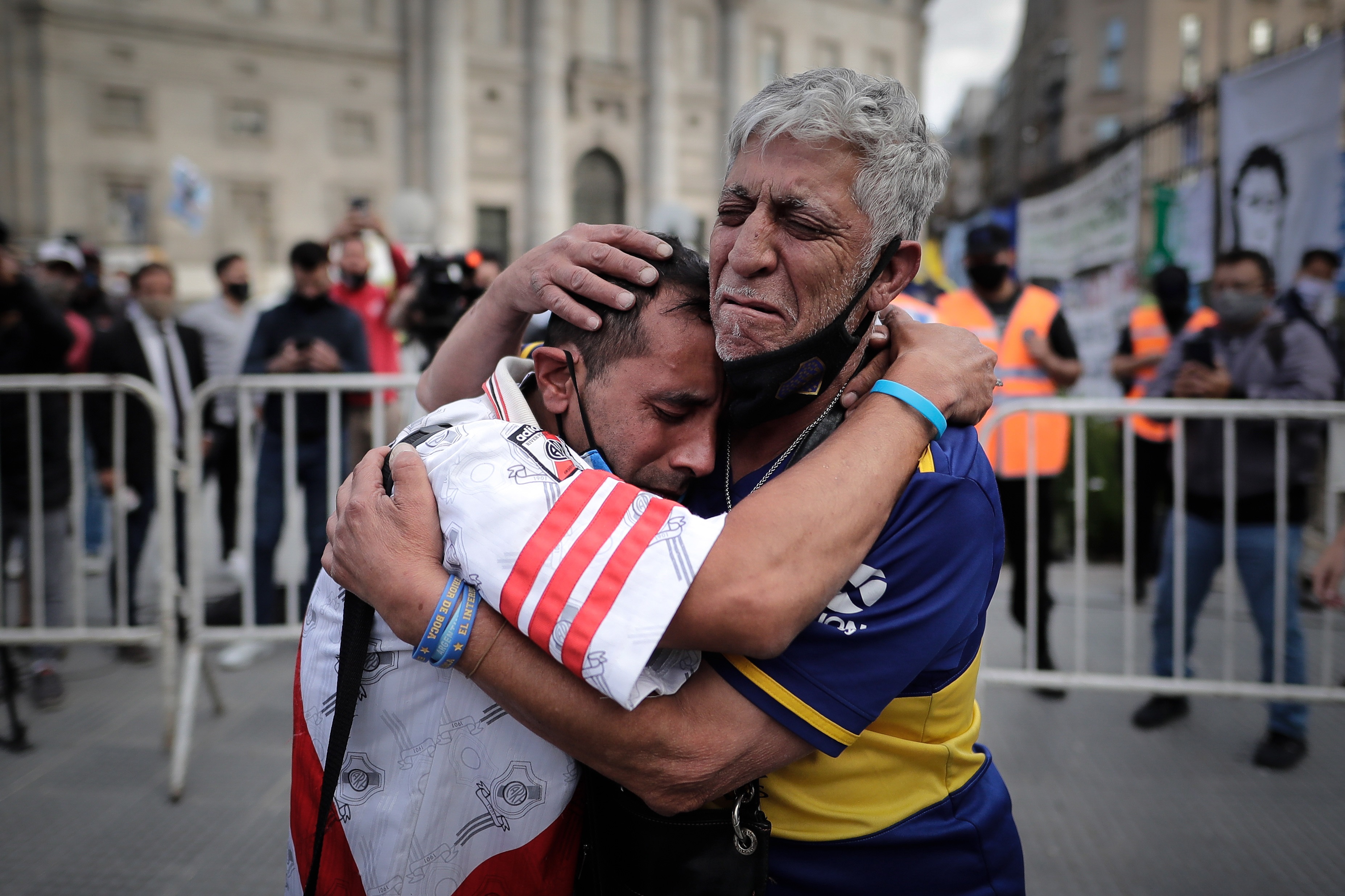 Fans react after visiting Maradona&#39;s funeral chapel installed at the Casa Rosada [Juan Ignacio Roncoroni/EPA]