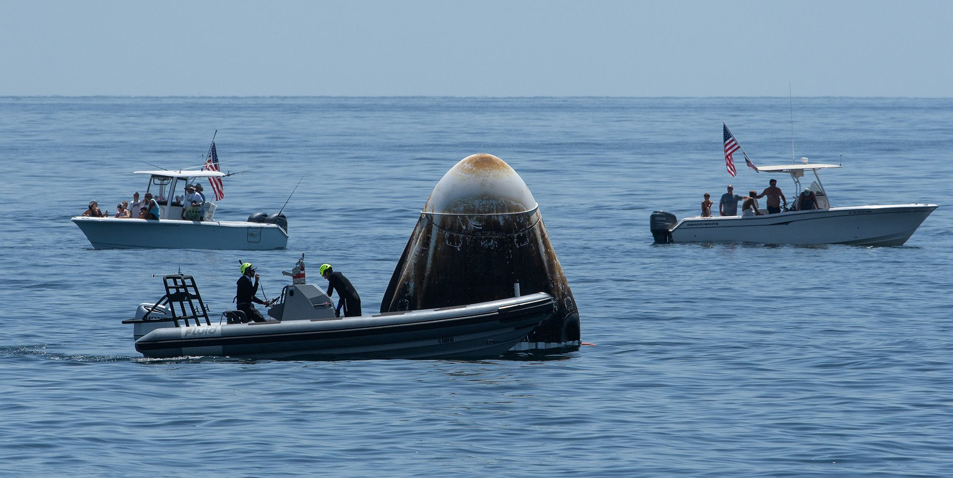 A recovery support team and recreational boaters surround the SpaceX&#39;s Crew Dragon capsule spacecraft off the coast of Pensacola, Florida on August 2 [File: Bloomberg]