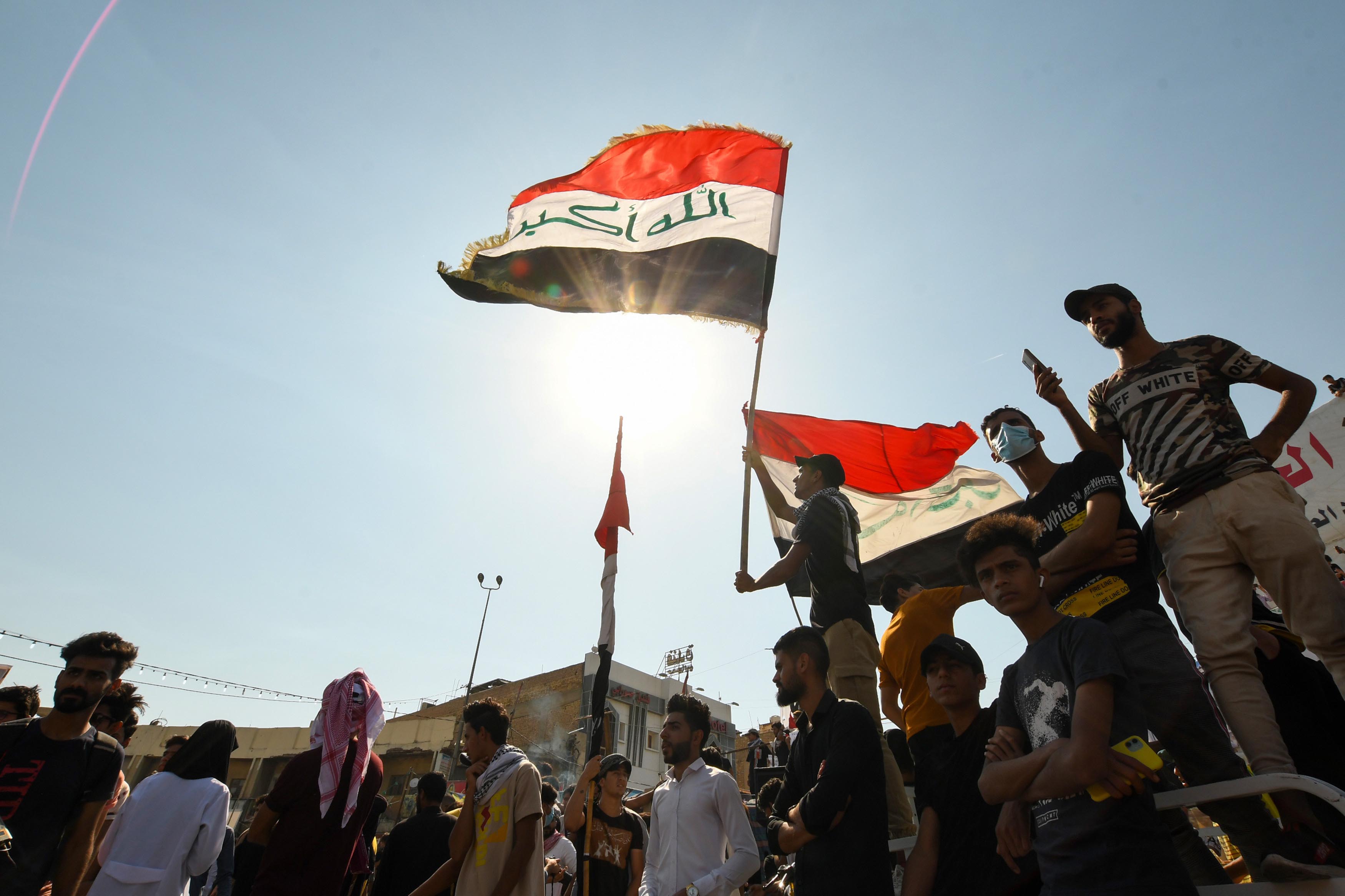 Iraqi demonstrators chant slogans during a gathering in Haboubi Square in the southern city of Nasiriya to demand an overhaul of the political system [File: Assaad al-Niyazi/AFP]