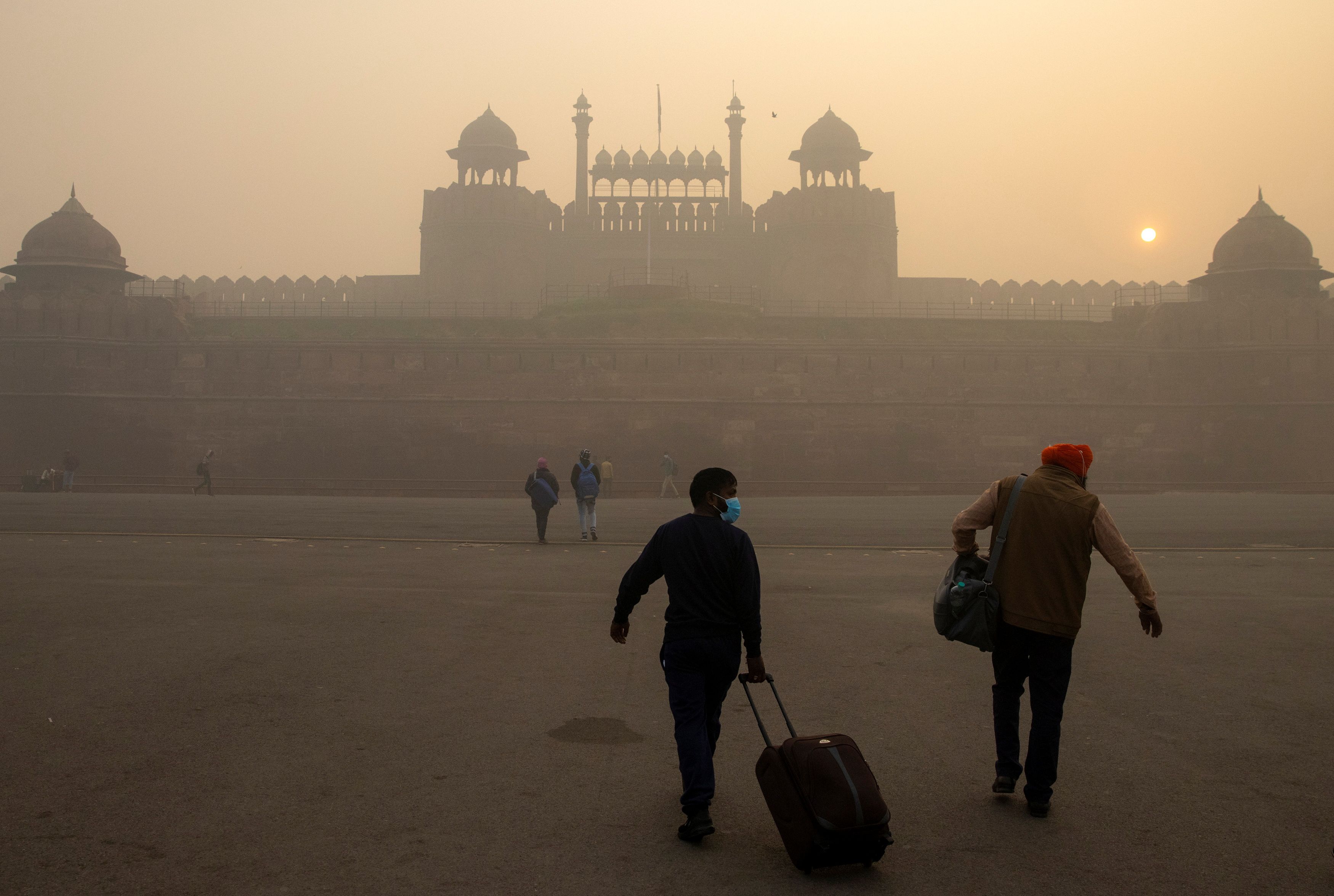 People visit the Red Fort on a smoggy morning in the old quarters of Delhi, India, November 10, 2020 [File: Danish Siddiqui/Reuters]