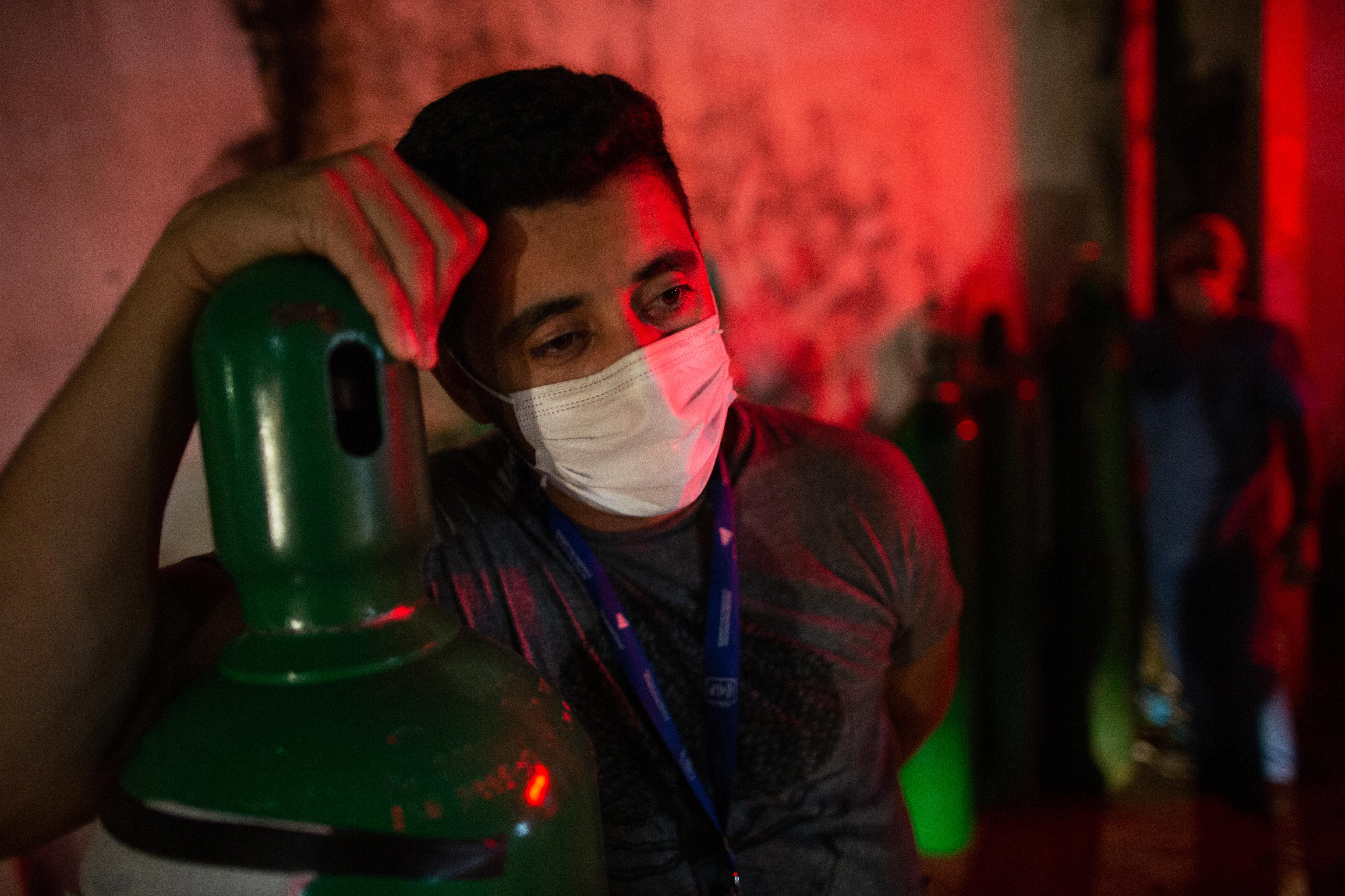 A man holds an oxygen tank in Manaus on January 15, as medical workers are battling a shortage of oxygen and other essential equipment to respond to a surge in COVID-19 cases [File: Michael Dantas/AFP]