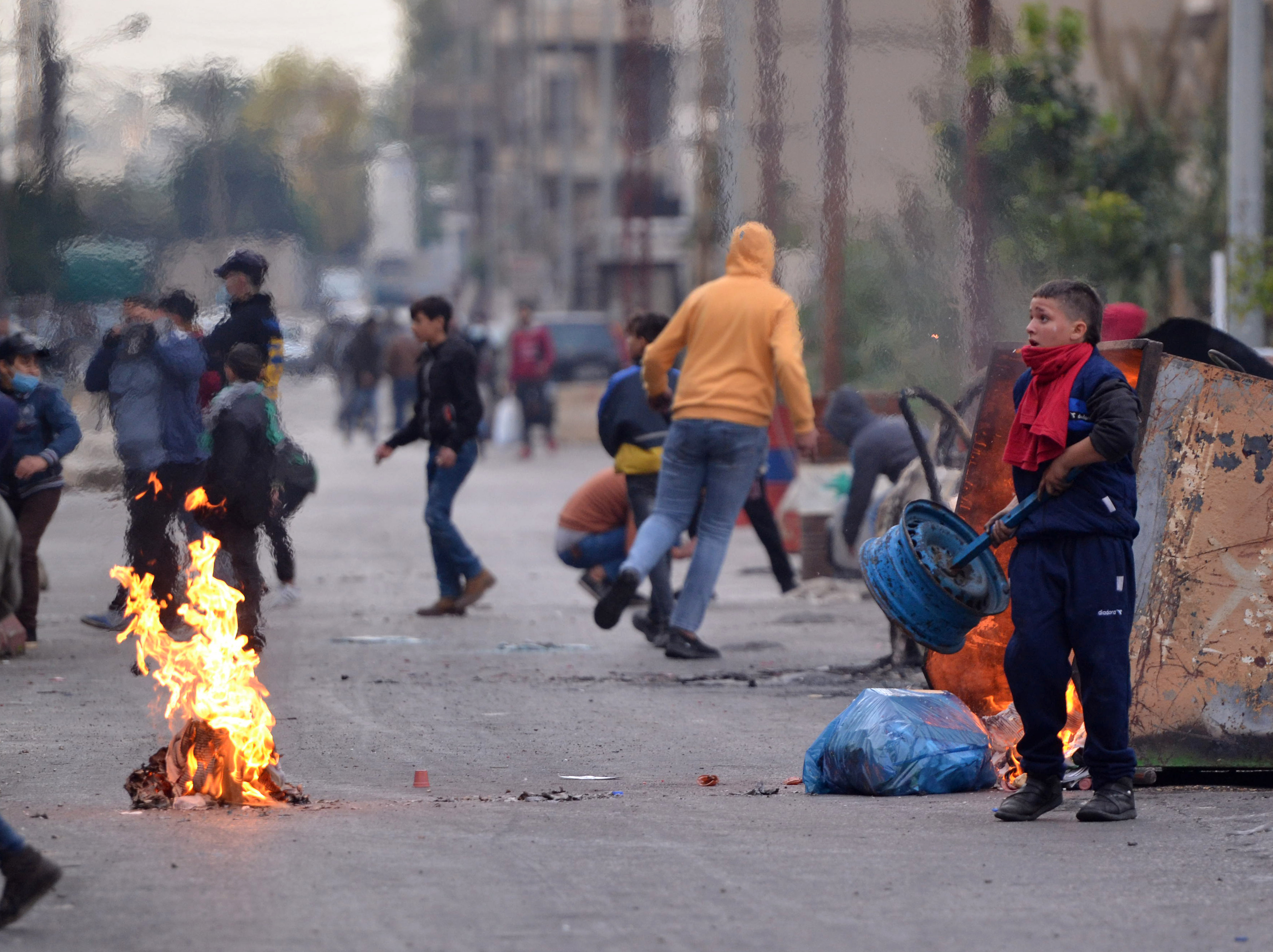 Lebanese protesters gather outside the Serail, headquarters of the Governorate of North Lebanon, during ongoing demonstrations that marked the third consecutive night of protests [Fathi AL-MASRI/AFP]