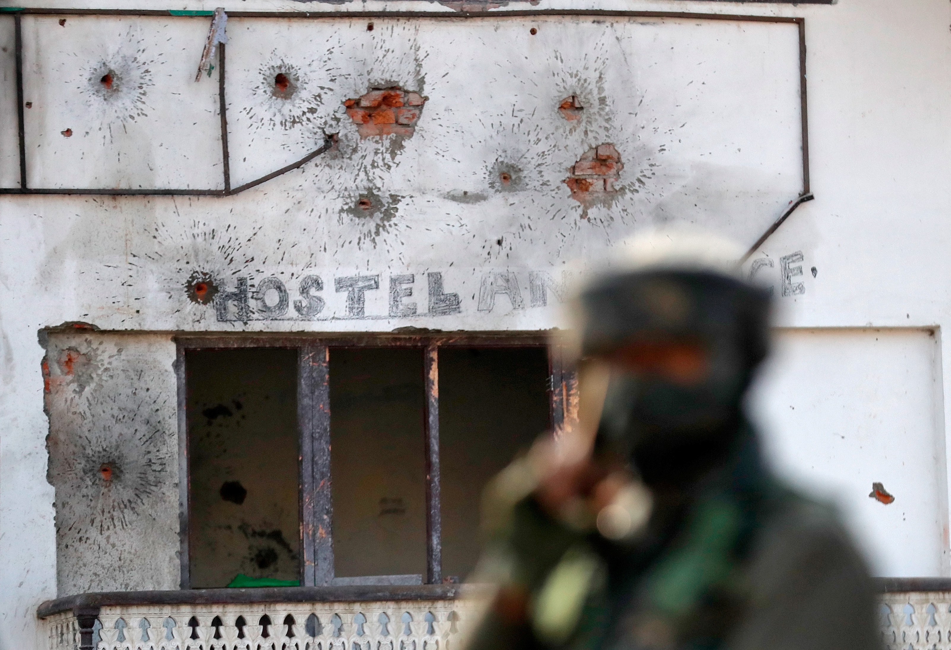 Bullet holes seen on the wall of a house after a gun battle between Indian army soldiers and suspected rebels on the outskirts of Srinagar on December 30, 2020 [Danish Ismail/Reuters]