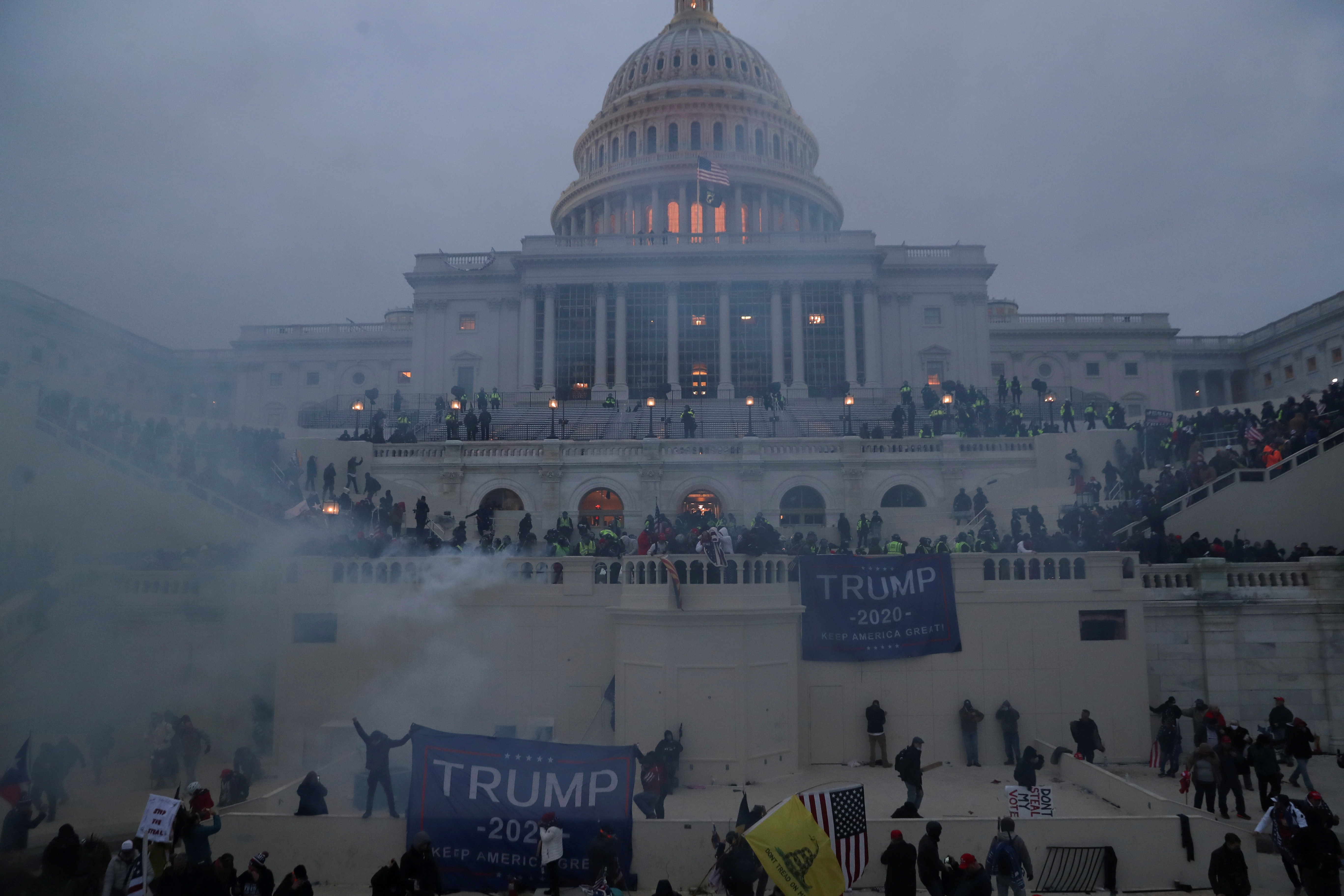 Police officers stand guard as supporters of United States President Donald Trump gather in front of the US Capitol Building in Washington, DC, the US, on January 6, 2021 [Leah Millis/Reuters]