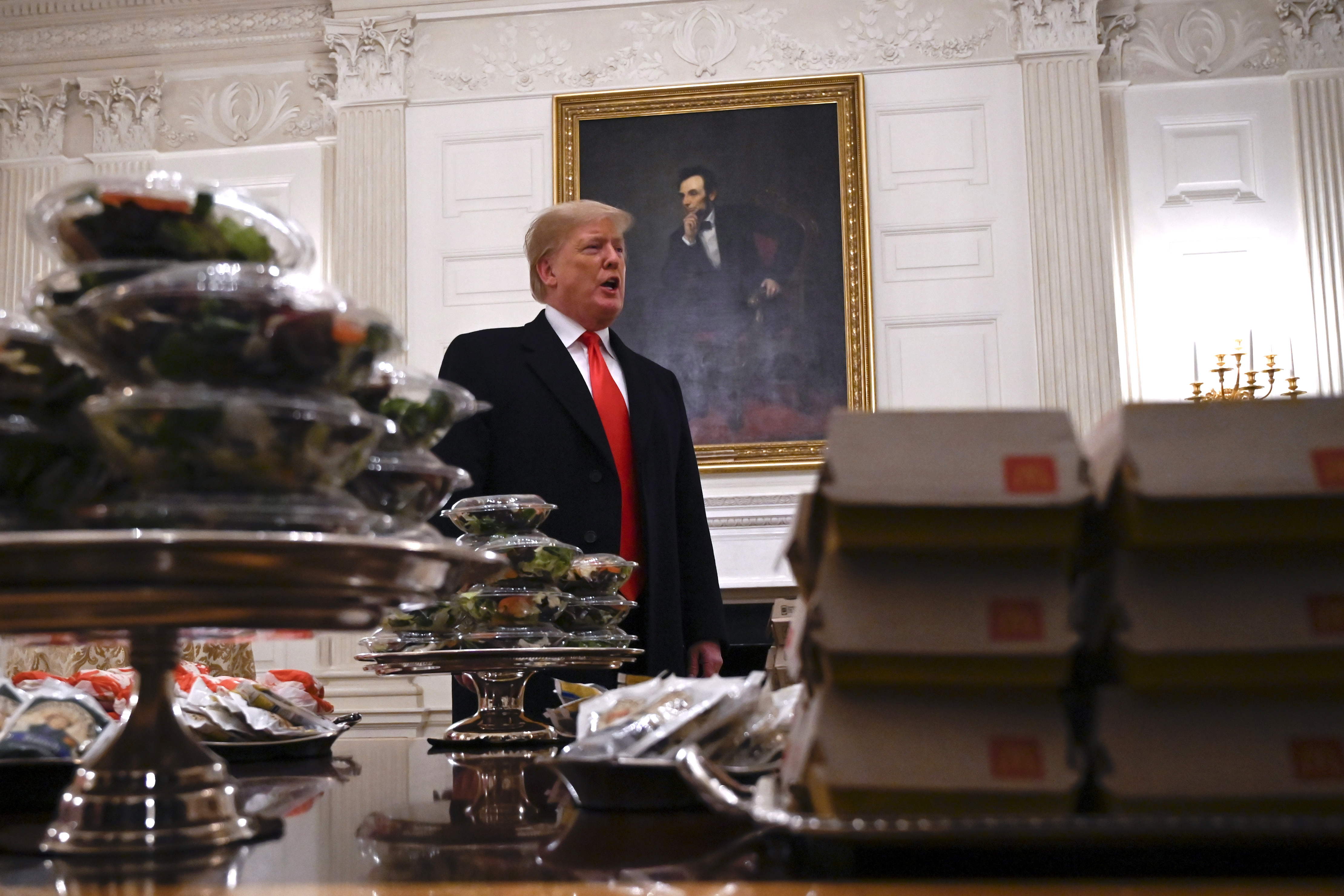 President Donald Trump ends his presidency with a litany of notable, but perhaps forgotten, moments, including the massive fast food dinner he served to college football players in 2019 [Susan Walsh/AP Photo]