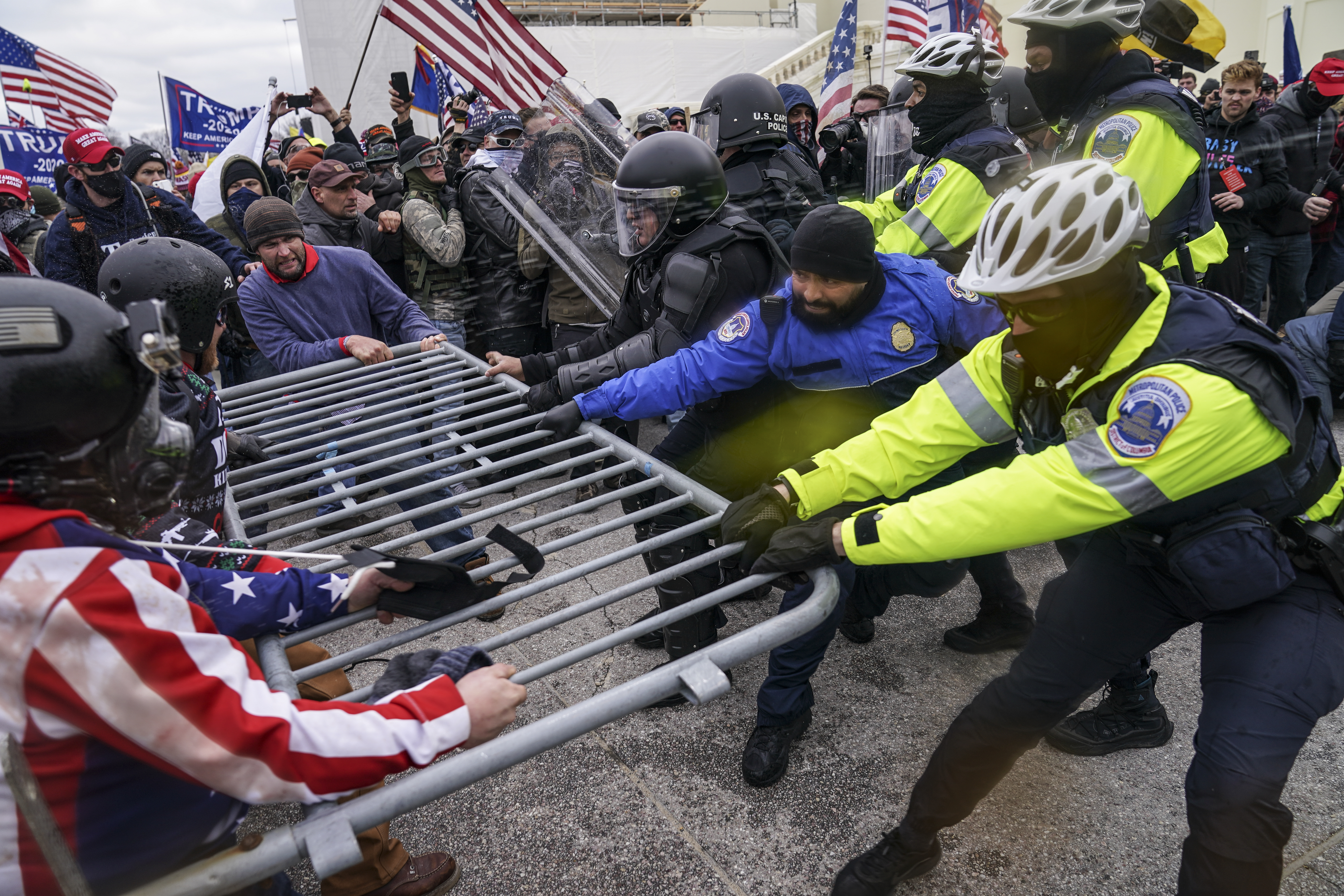 Trump supporters try to break through a police barrier, Jan 6, 2021, at the Capitol in Washington, DC [File: John Minchillo/AP Photo]