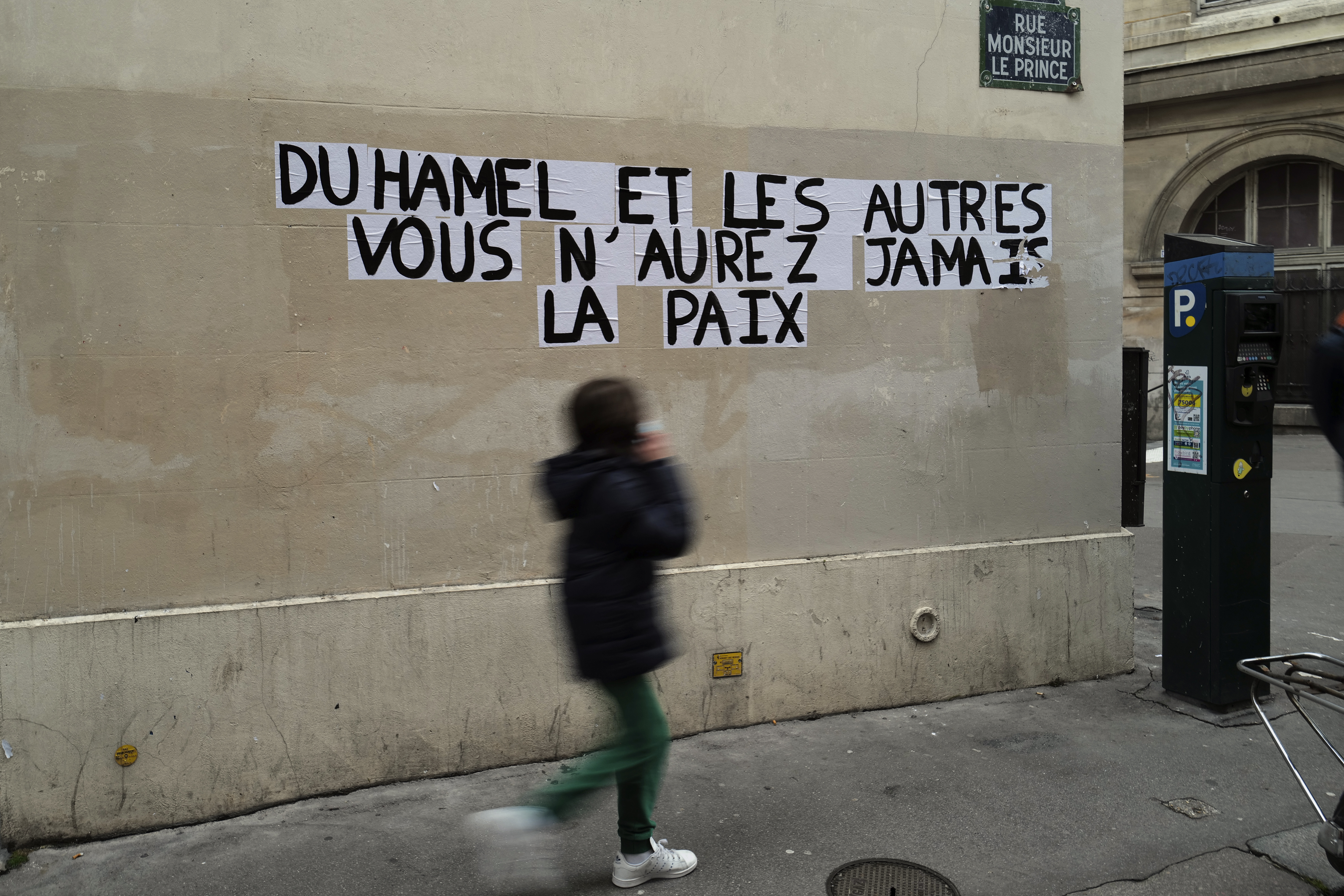A sign on a Parisian wall reads &#39;Duhamel, and the others, you will never be in peace&#39;, referring to the prominent French political expert Olivier Duhamel, who is accused of raping his stepson [Francois Mori/AP]