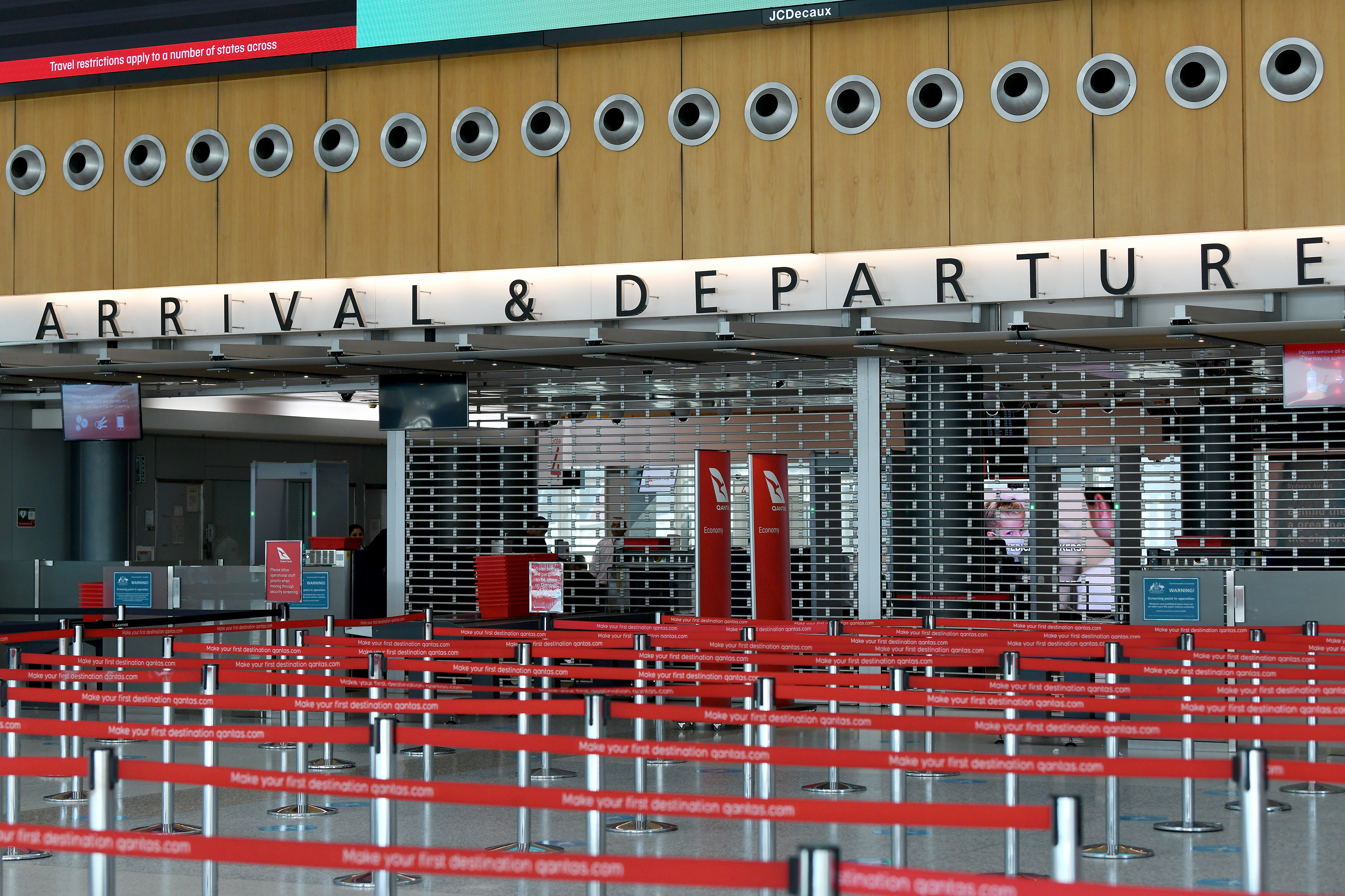 An empty arrivals and departures security point at the Qantas terminal at Sydney Airport. Australia says it may keep its borders close throughout 2021 even as it rolls out vaccinations [File: Bianca de Marchi/EPA]