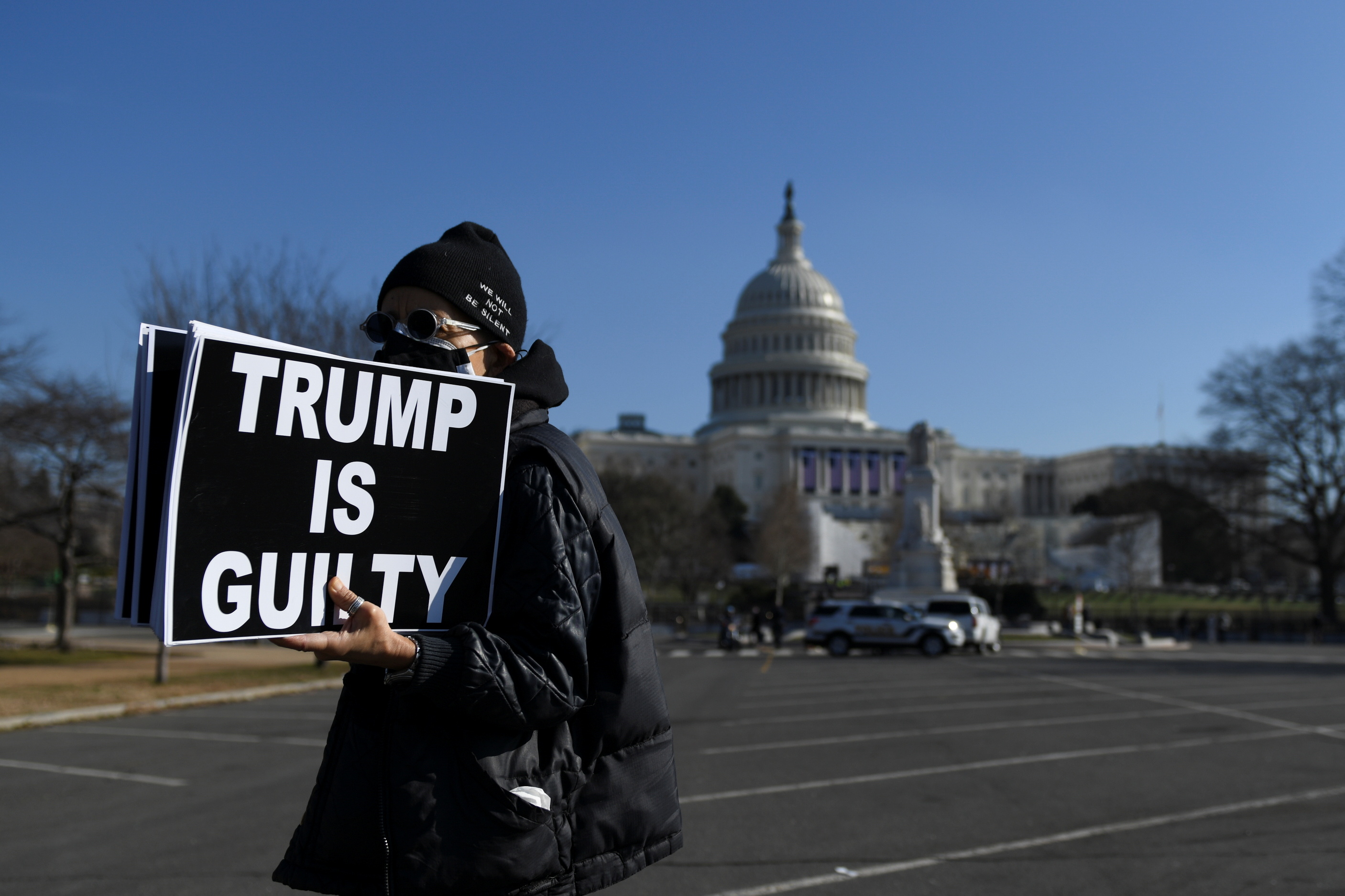 Laurie Arbeiter protests against Donald Trump near the US Capitol building, as the House of Representatives debated articles of impeachment on January 13, 2021 [Brandon Bell/Reuters]