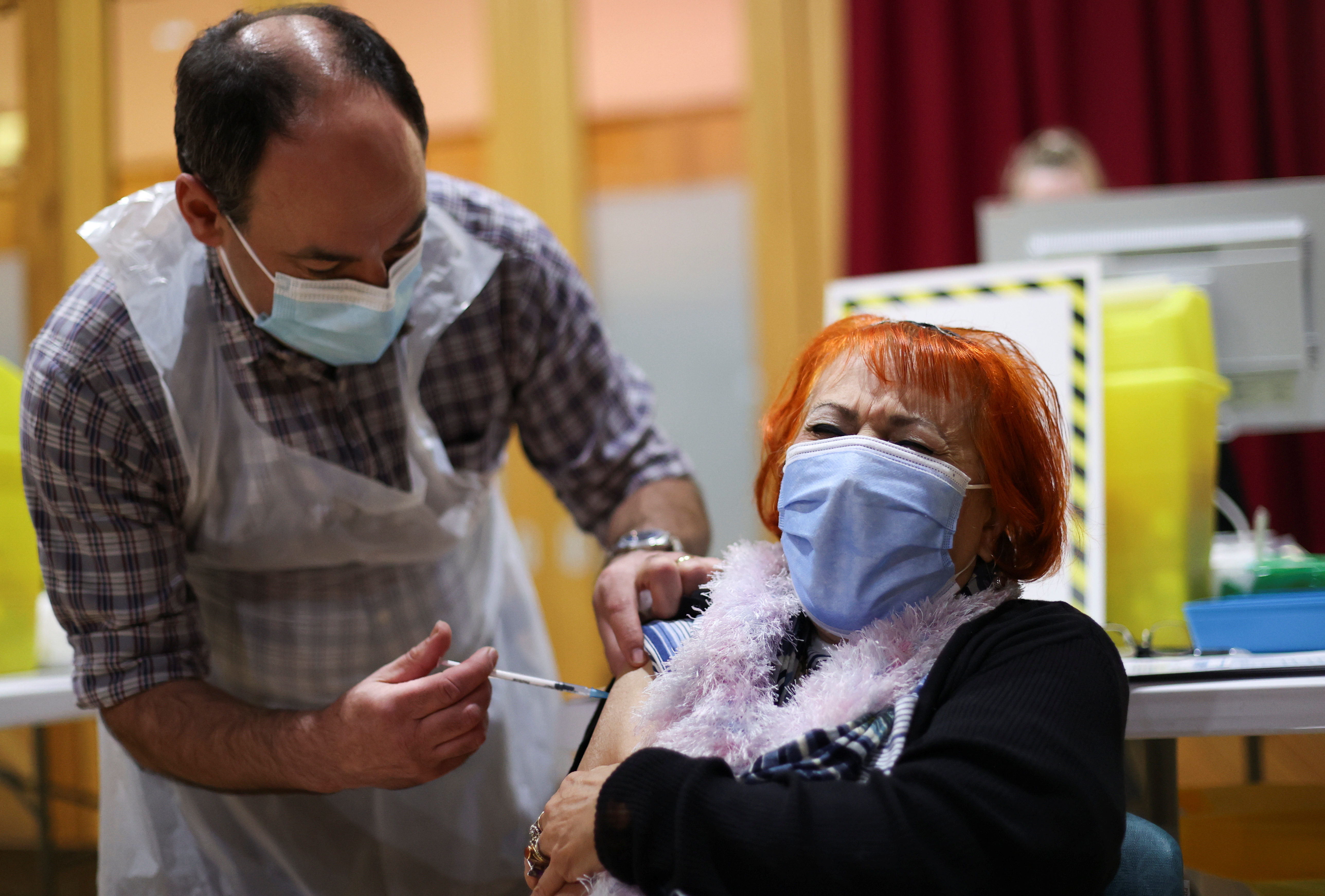A woman receives a vaccine against coronavirus in Chesterfield, UK on February 3 [Carl Recine/Reuters]