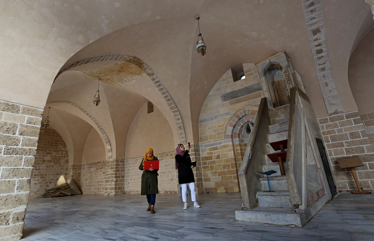 Nisma al-Sallaq and Mayar Humaid started their project to archive Gaza&#39;s historical sites and buildings in 2014 [Ashraf Amra/Al Jazeera]