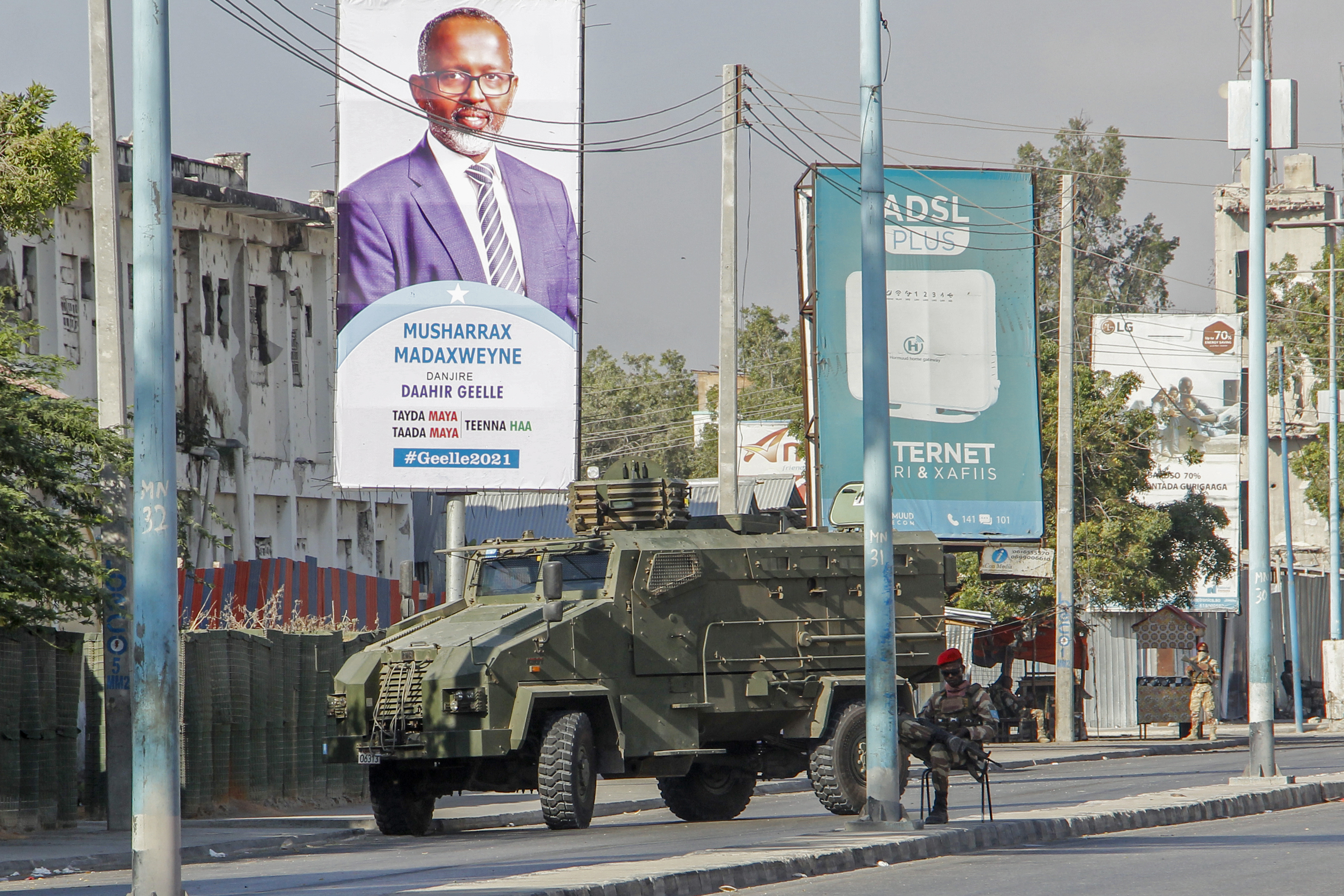 Security forces block a street with an armoured personnel carrier during protests against the government and the delay of the country&#39;s election in the capital Mogadishu, Somalia, Feb 19, 2021. [AP Photo]