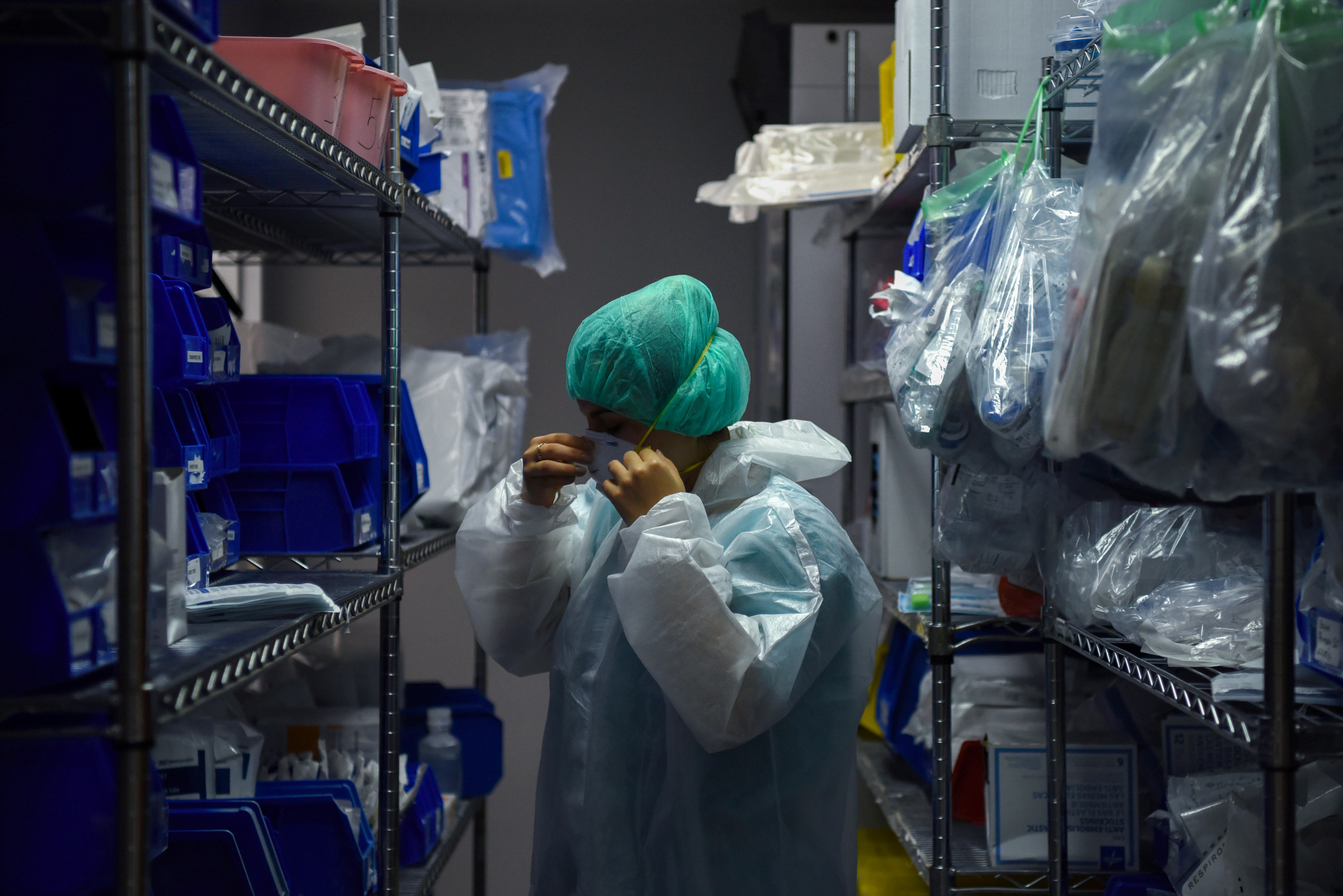 A medical worker puts on personal protective equipment at the United Memorial Medical Center’s coronavirus intensive care unit in Houston, Texas, US [File: Callaghan O&#39;Hare/Reuters]