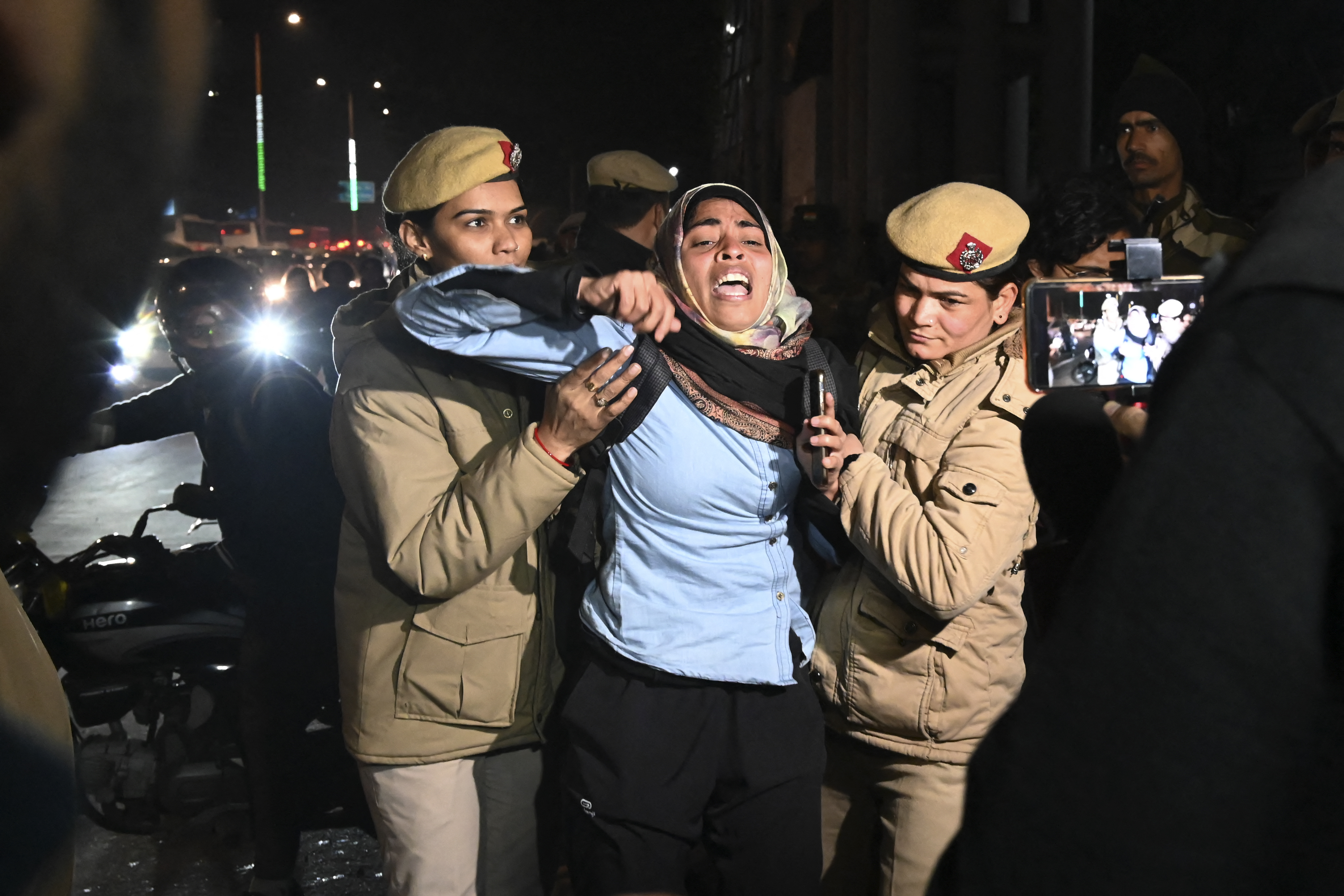 Police detain a woman during a protest outside the police headquarters in New Delhi on January 30, 2020 to demand action against a suspected Hindu nationalist who opened fire on demonstrators during a protest against a controversial citizenship law, outside Jamia Millia Islamia university [File: Prakash Singh/AFP]