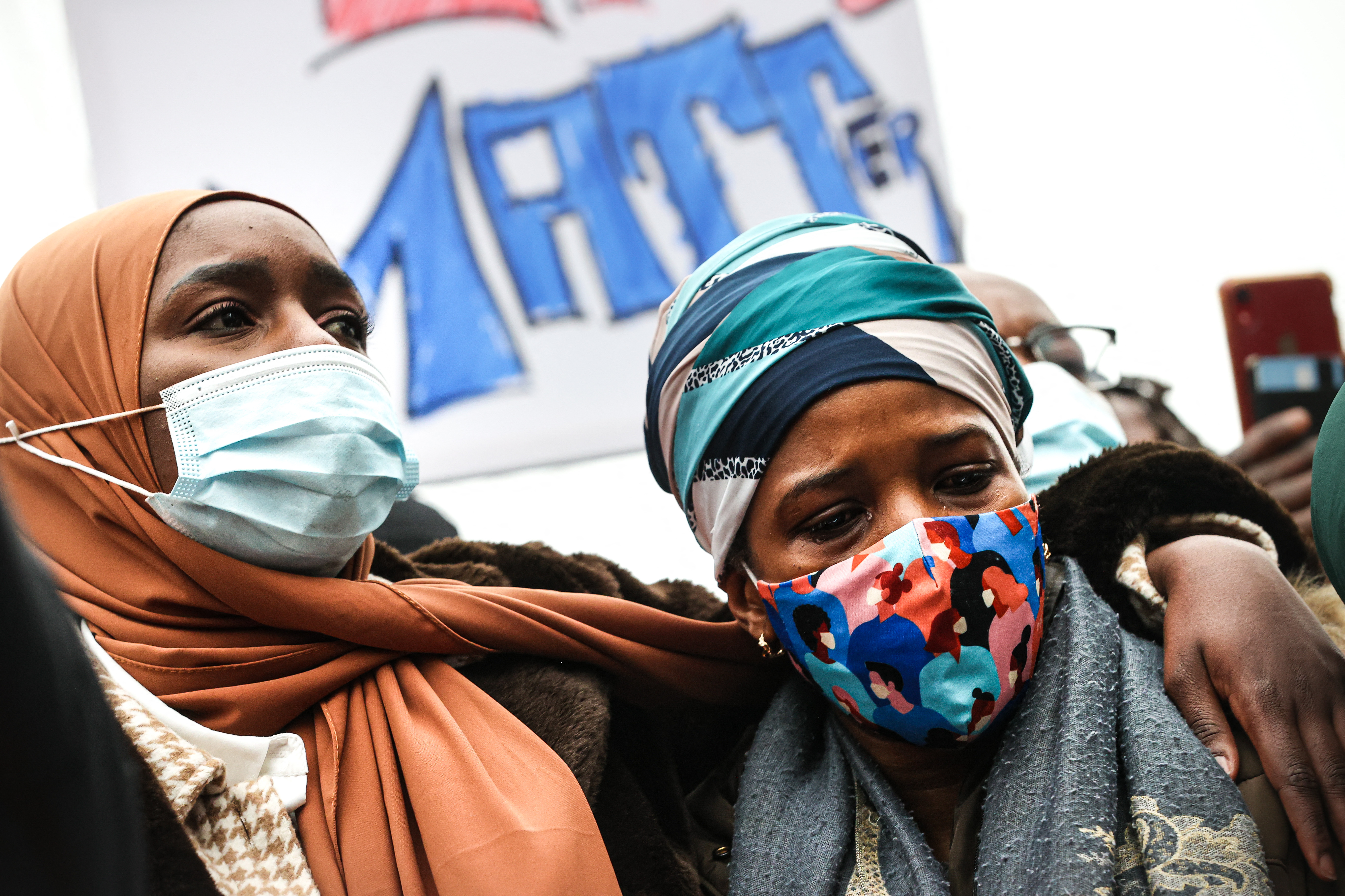 Ibrahima&#39;s mother takes part in a demonstration on January 13, 2021 outside the police station in Brussels, where her son was held before he was rushed to hospital and died on January 9, 2021 [File: AFP/Virginie Lefour]