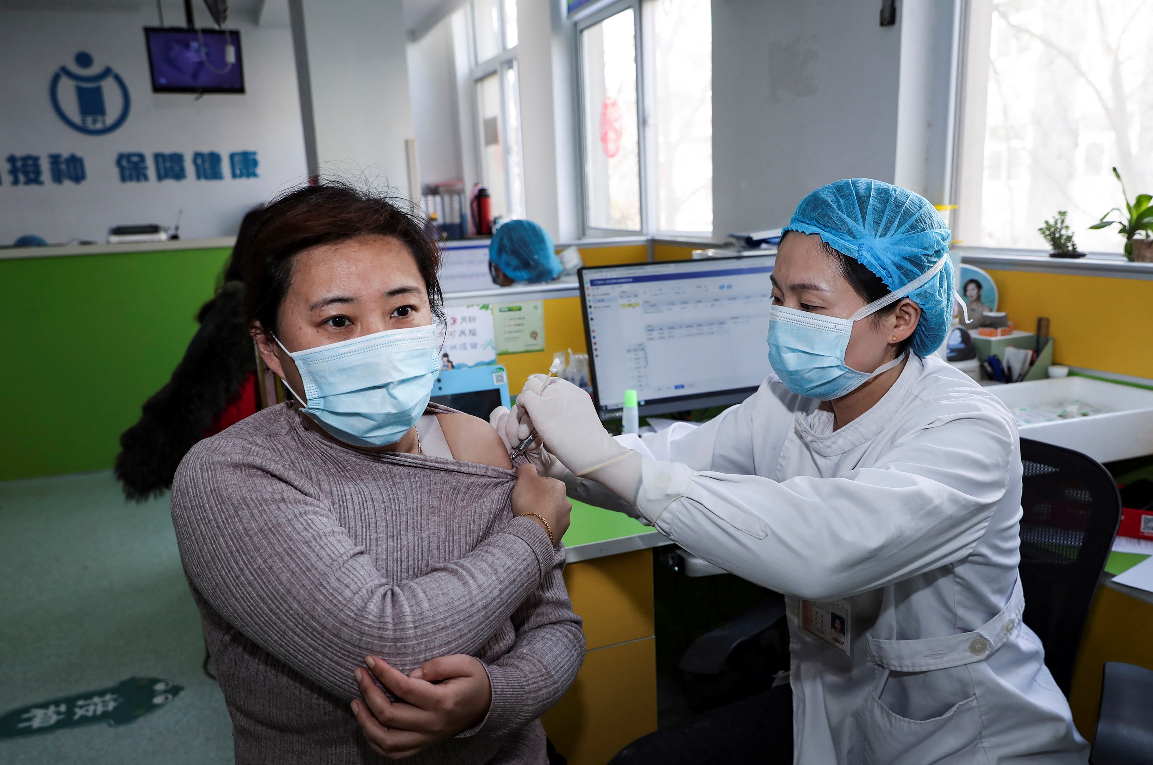 A woman in Huaian in eastern China&#39;s Jiangsu province receives her vaccine in January. China&#39;s success at tackling COVID-19 means people see little urgency to getting the jab [File: Stringer/AFP]