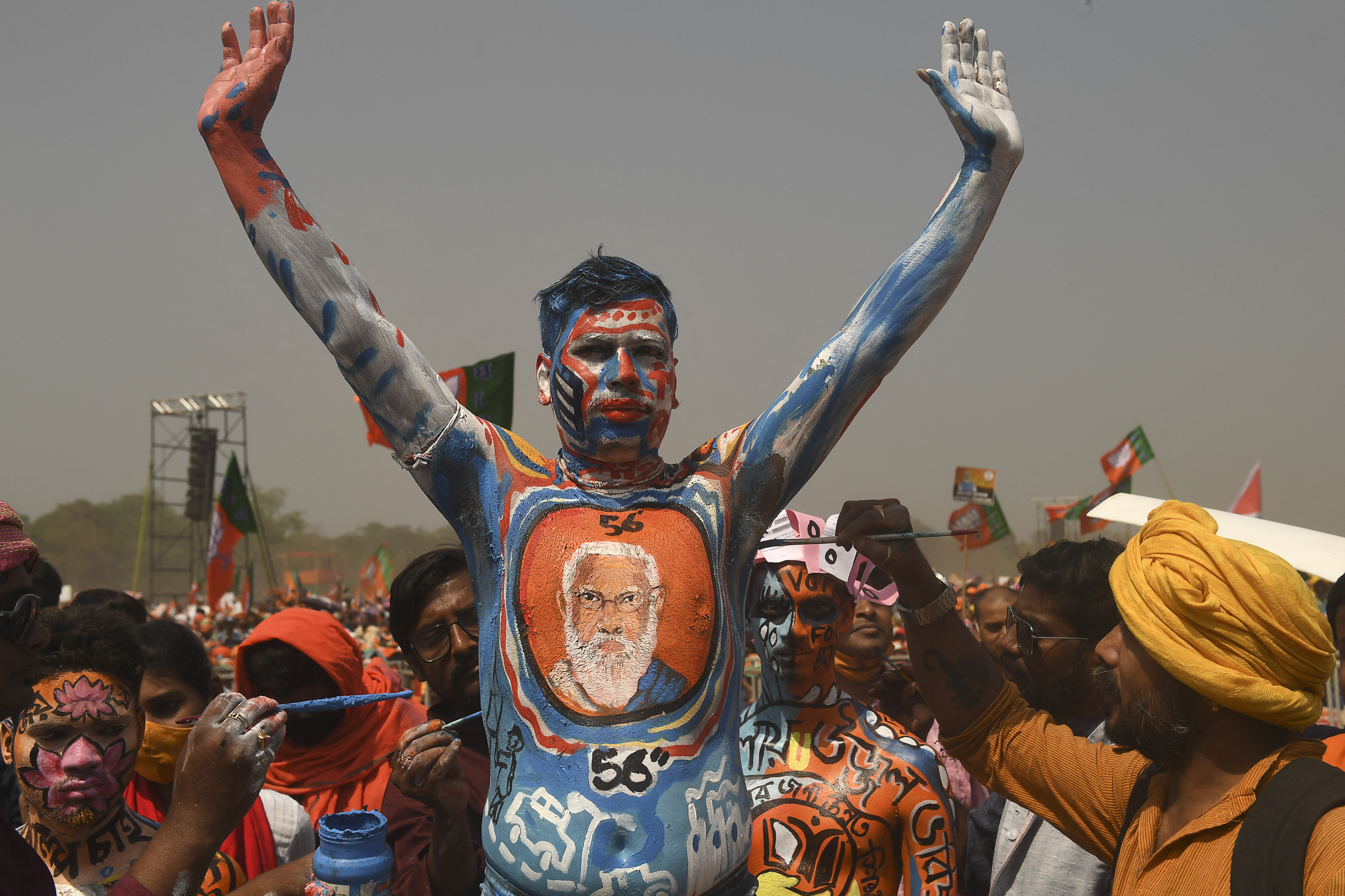 A BJP supporter with his body painted gestures during an election rally addressed by India&#39;s Prime Minister Narendra Modi in Kolkata [Dibyangshu Sarkar/AFP]