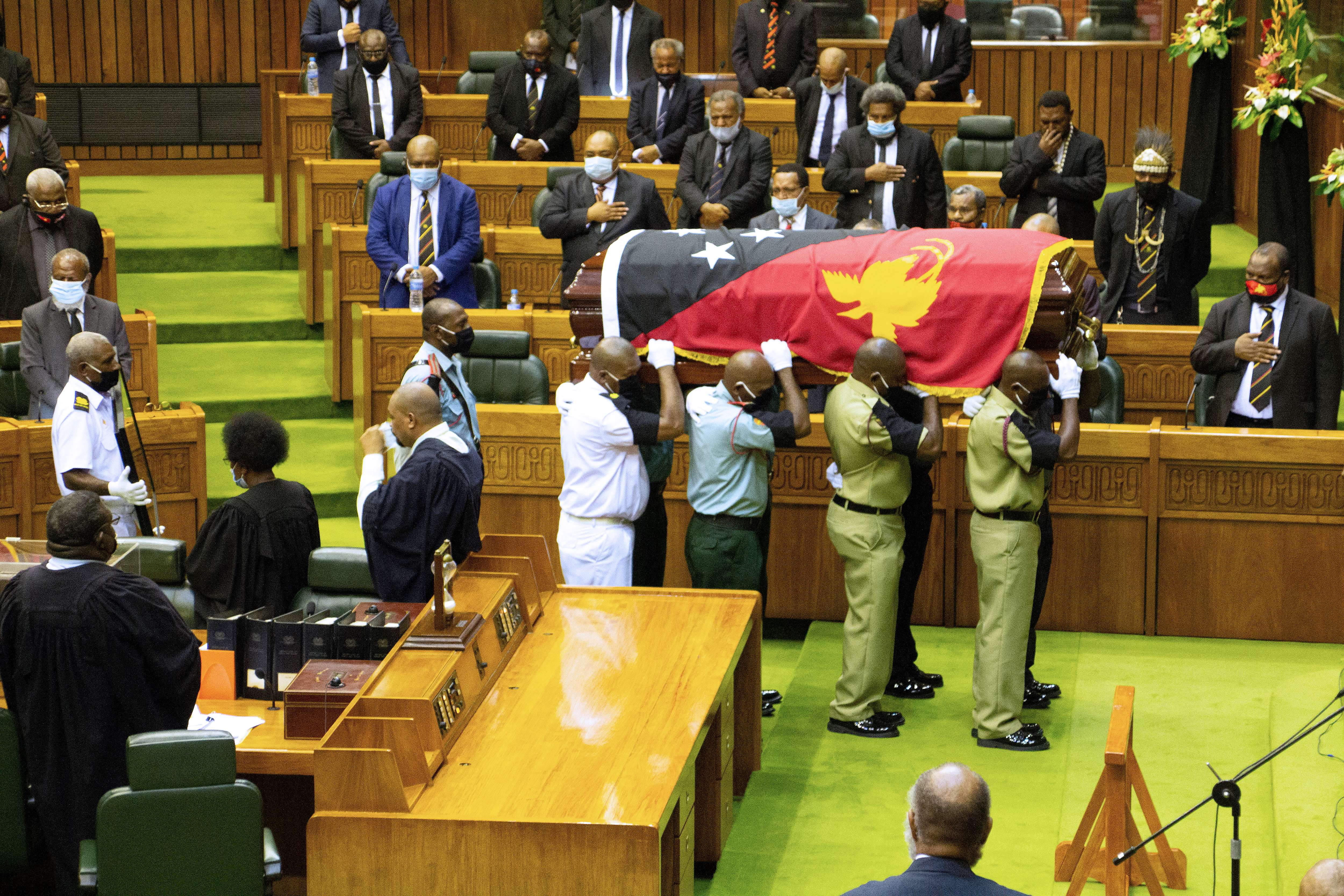 Amid a surge in COVID-19 cases, the WHO is urging people attending this weekend&#39;s funeral for former Prime Minister Michael Somare to follow virus protocols [Andrew Kutan/AFP]