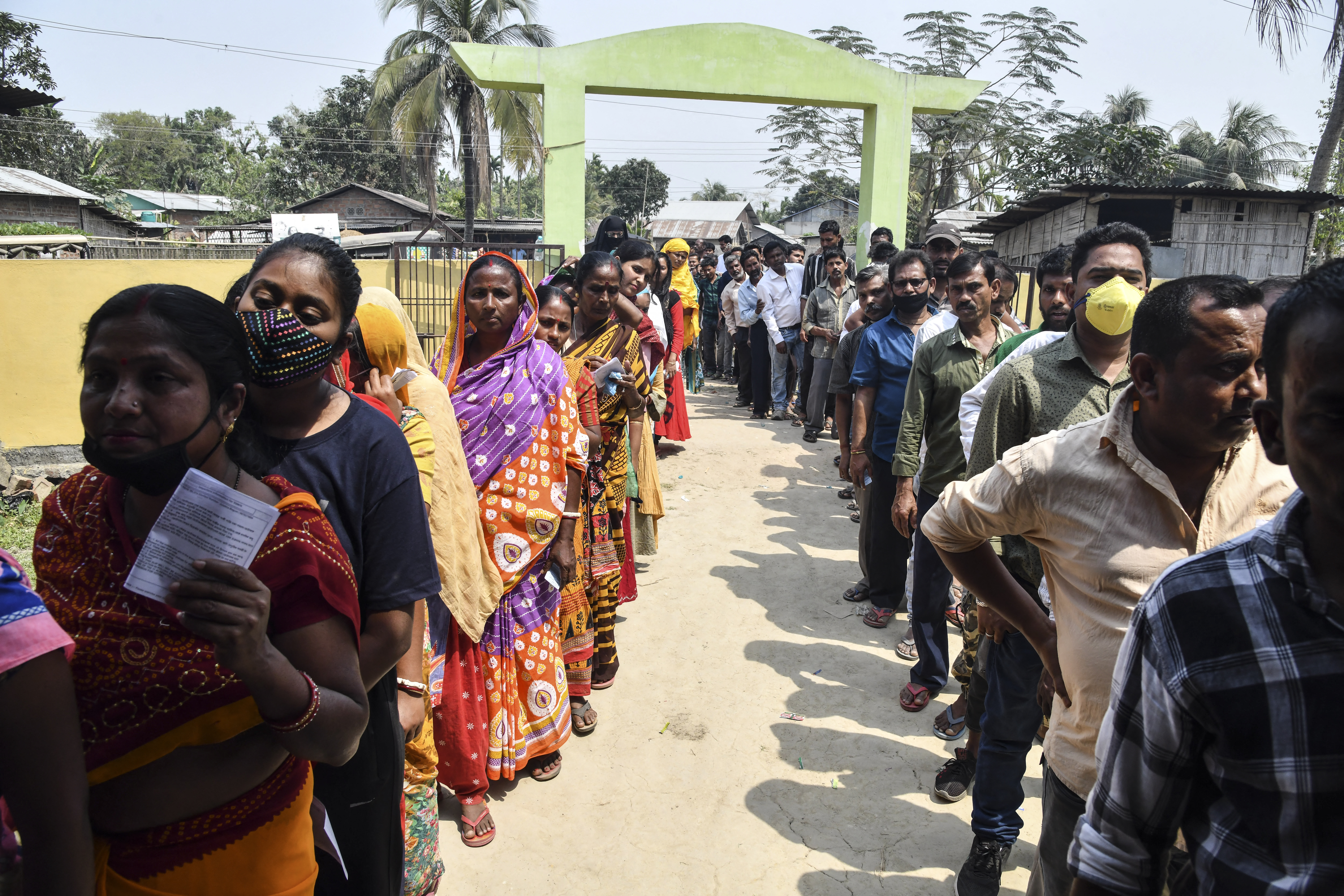 Voters queue to cast their ballots during phase one of Assam&#39;s state election in Koliabor [Dibyangshu Sarkar/AFP]