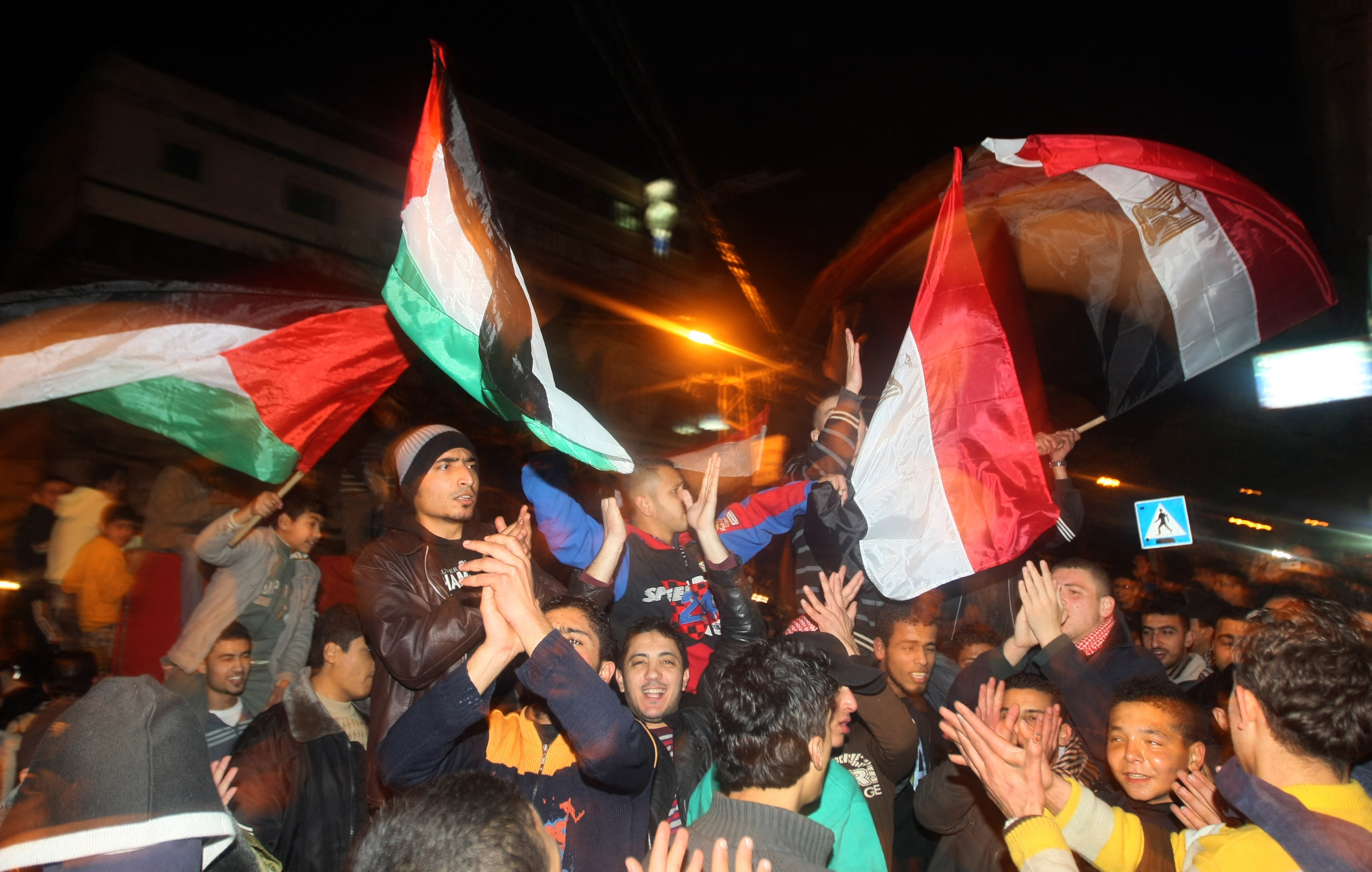 Palestinians wave the Palestinian and Egyptian flags, as they celebrate in Gaza on February 11, 2011 following news that Egyptian President Hosni Mubarak had stepped down [File: AFP/ Mahmud Hams]