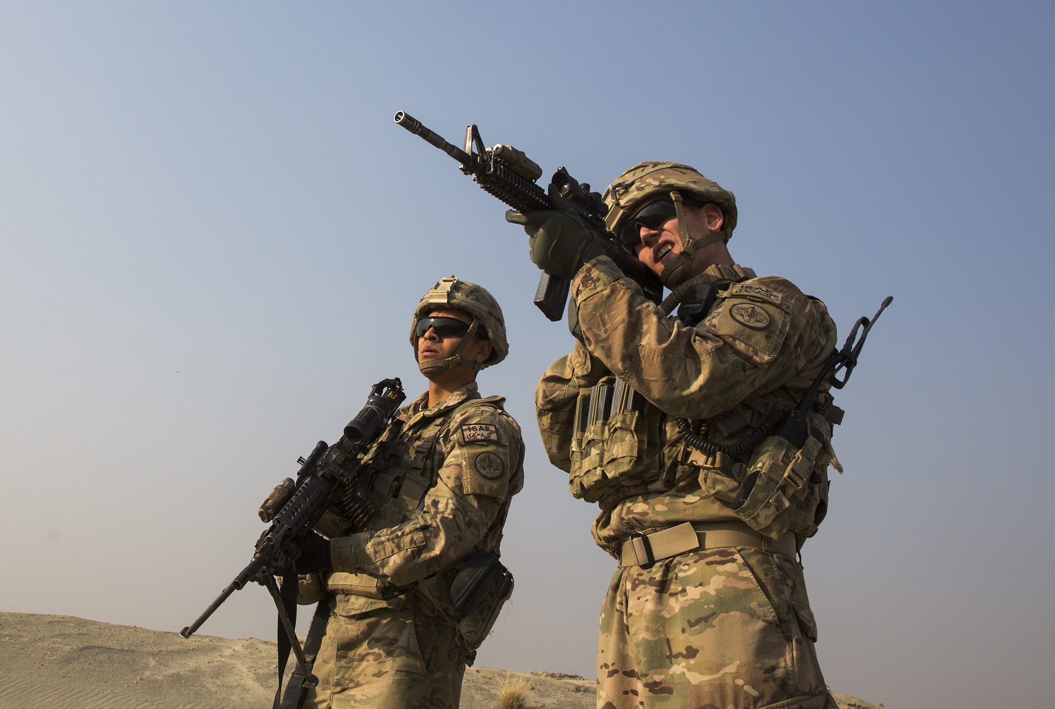 A US soldier uses the optic on his rifle to observe Afghans in the distance, near forward operating base Gamberi in Laghman province of Afghanistan [File: Lucas Jackson/Reuters]