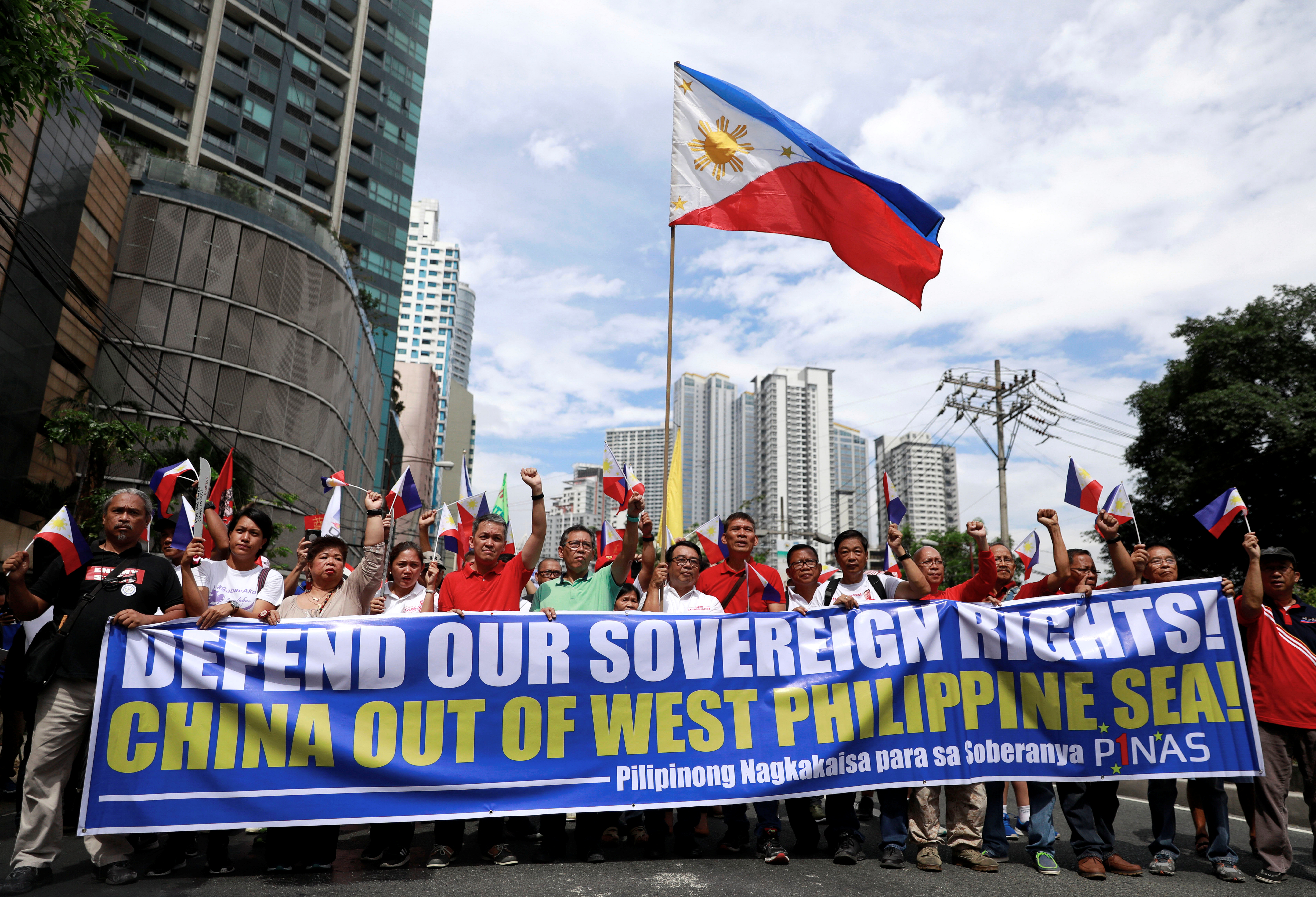 Filipino activists and opposition leaders march to protest against the presence of Chinese vessels in South China Sea at the Chinese Embassy in Makati City, Philippines, April 9, 2019 [File: Eloisa Lopez/ Reuters]