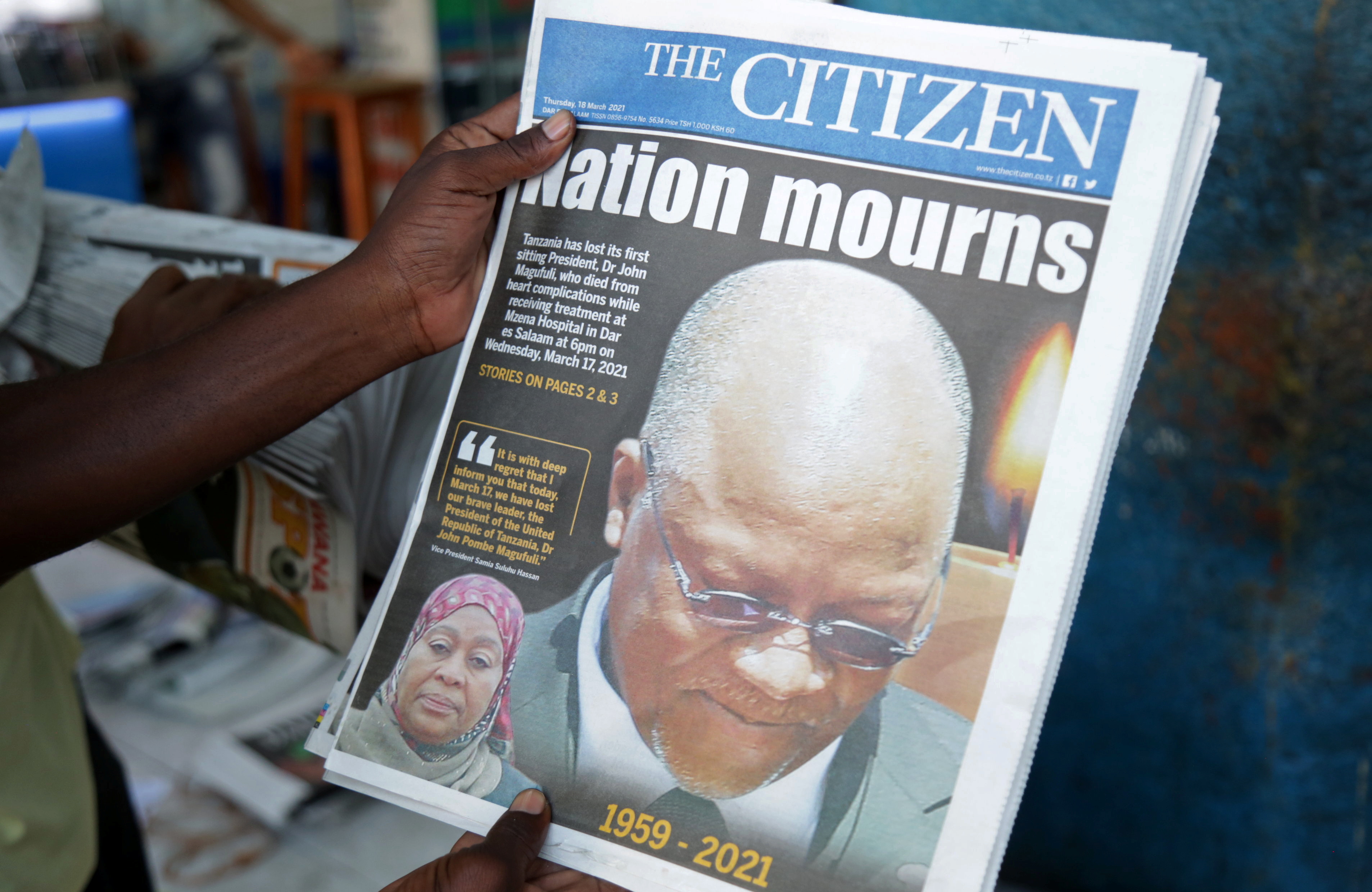 A man holds a newspapers following the death of Tanzania&#39;s President John Magufuli [Emmanuel Herman/Reuters]